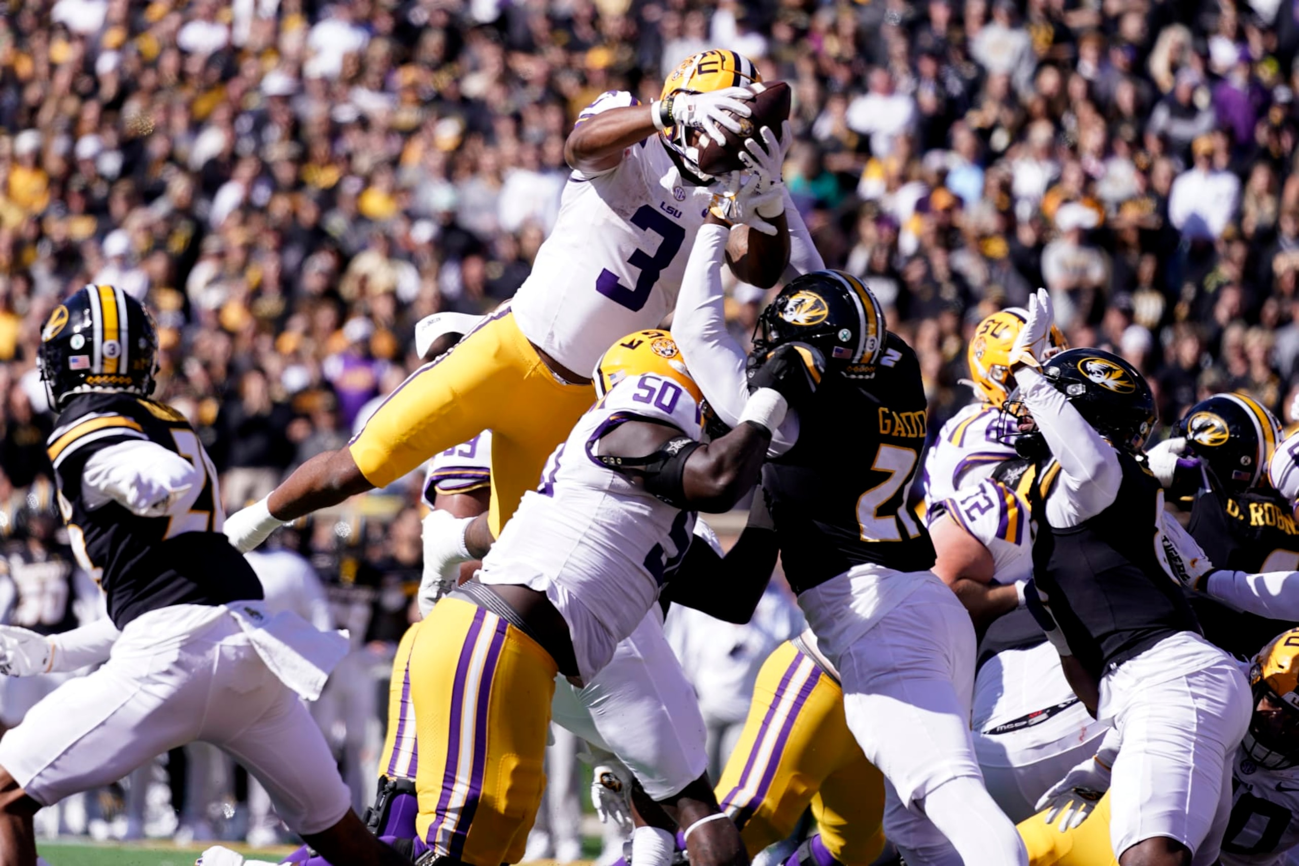 COLUMBIA, MISSOURI - OCTOBER 07: Running back Logan Diggs #3 of the LSU Tigers leaps into the endzone for a touchdown against the Missouri Tigers in the first half at Faurot Field/Memorial Stadium on October 07, 2023 in Columbia, Missouri. (Photo by Ed Zurga/Getty Images)