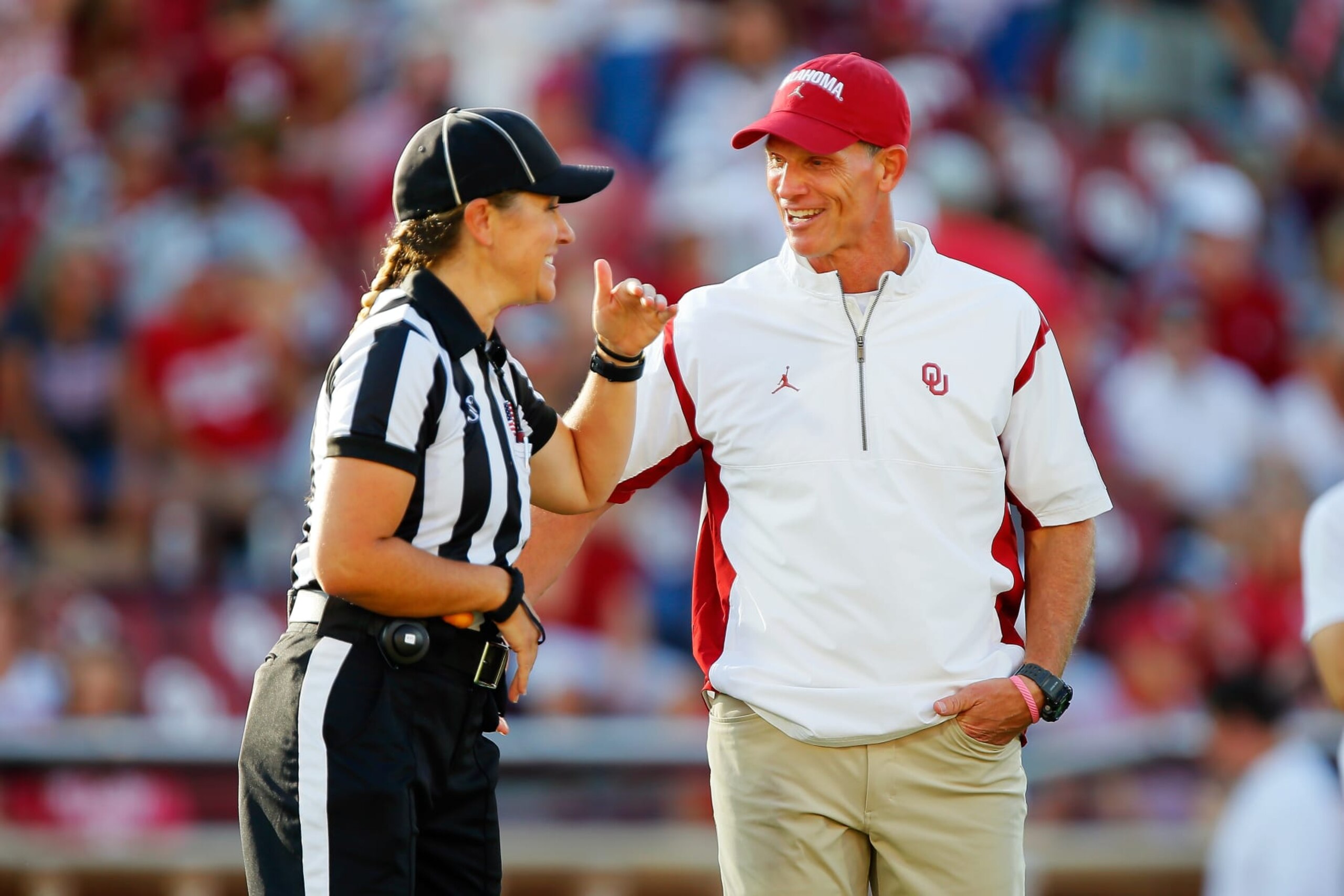 NORMAN, OKLAHOMA - SEPTEMBER 30:  Head line judge Catherine Conti talks with head coach Brent Venables of the Oklahoma Sooners before a game against the Iowa State Cyclones at Gaylord Family Oklahoma Memorial Stadium on September 30, 2023 in Norman, Oklahoma.  (Photo by Brian Bahr/Getty Images)