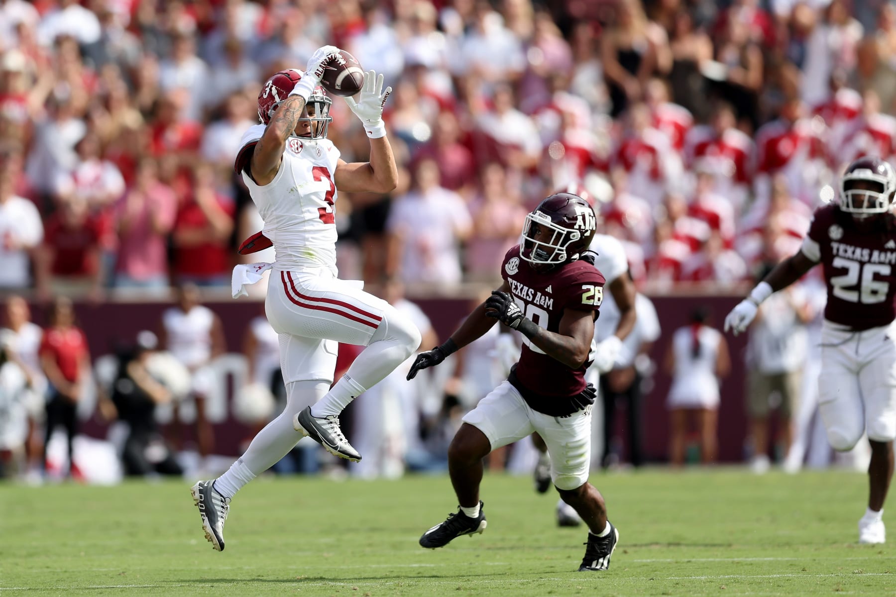 COLLEGE STATION, TEXAS - OCTOBER 07: Jermaine Burton #3 of the Alabama Crimson Tide catches a pass in front of Josh DeBerry #28 of the Texas A&M Aggies in the first half at Kyle Field on October 07, 2023 in College Station, Texas. (Photo by Tim Warner/Getty Images)