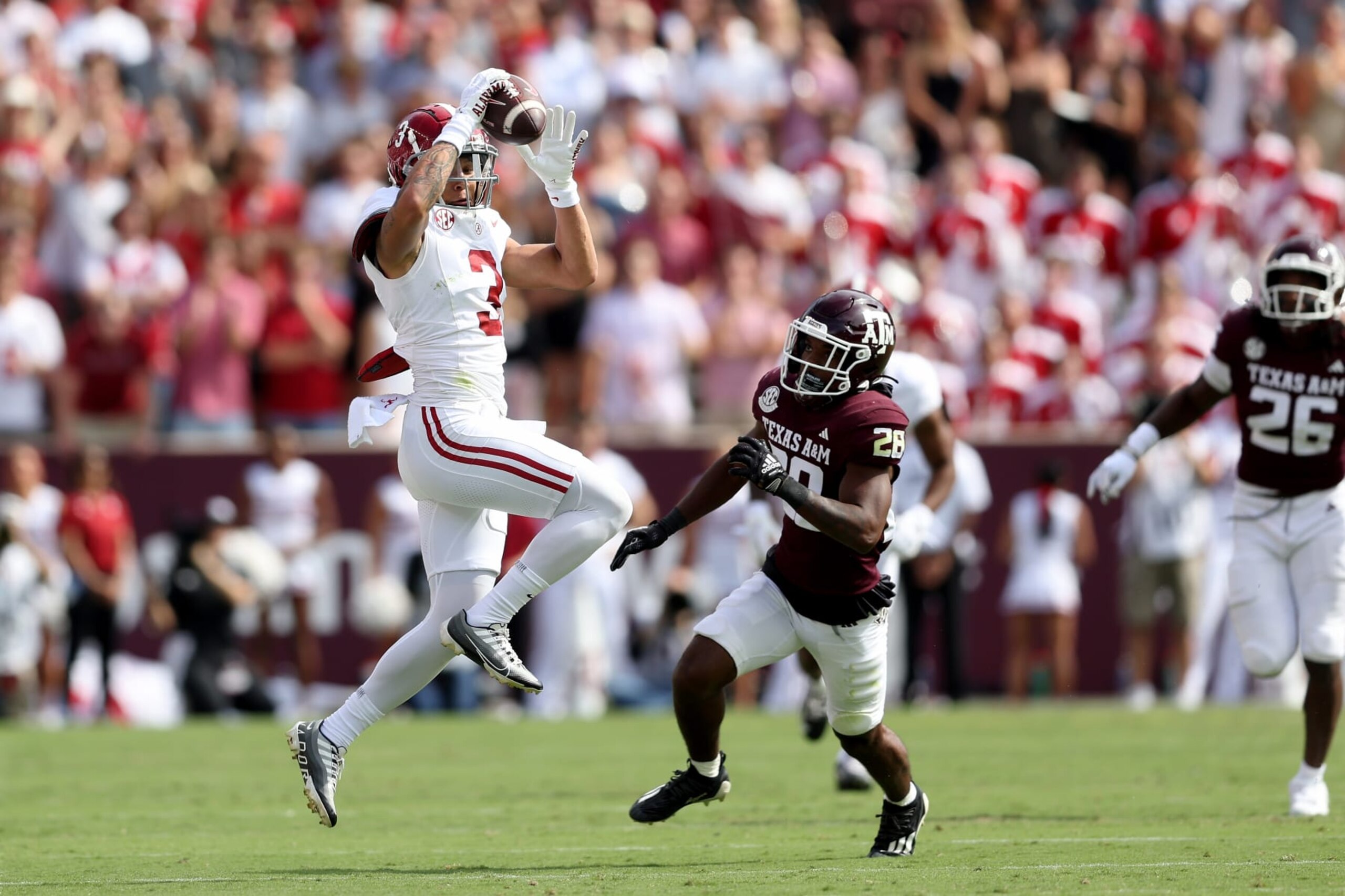 COLLEGE STATION, TEXAS - OCTOBER 07: Jermaine Burton #3 of the Alabama Crimson Tide catches a pass in front of Josh DeBerry #28 of the Texas A&M Aggies in the first half at Kyle Field on October 07, 2023 in College Station, Texas. (Photo by Tim Warner/Getty Images)