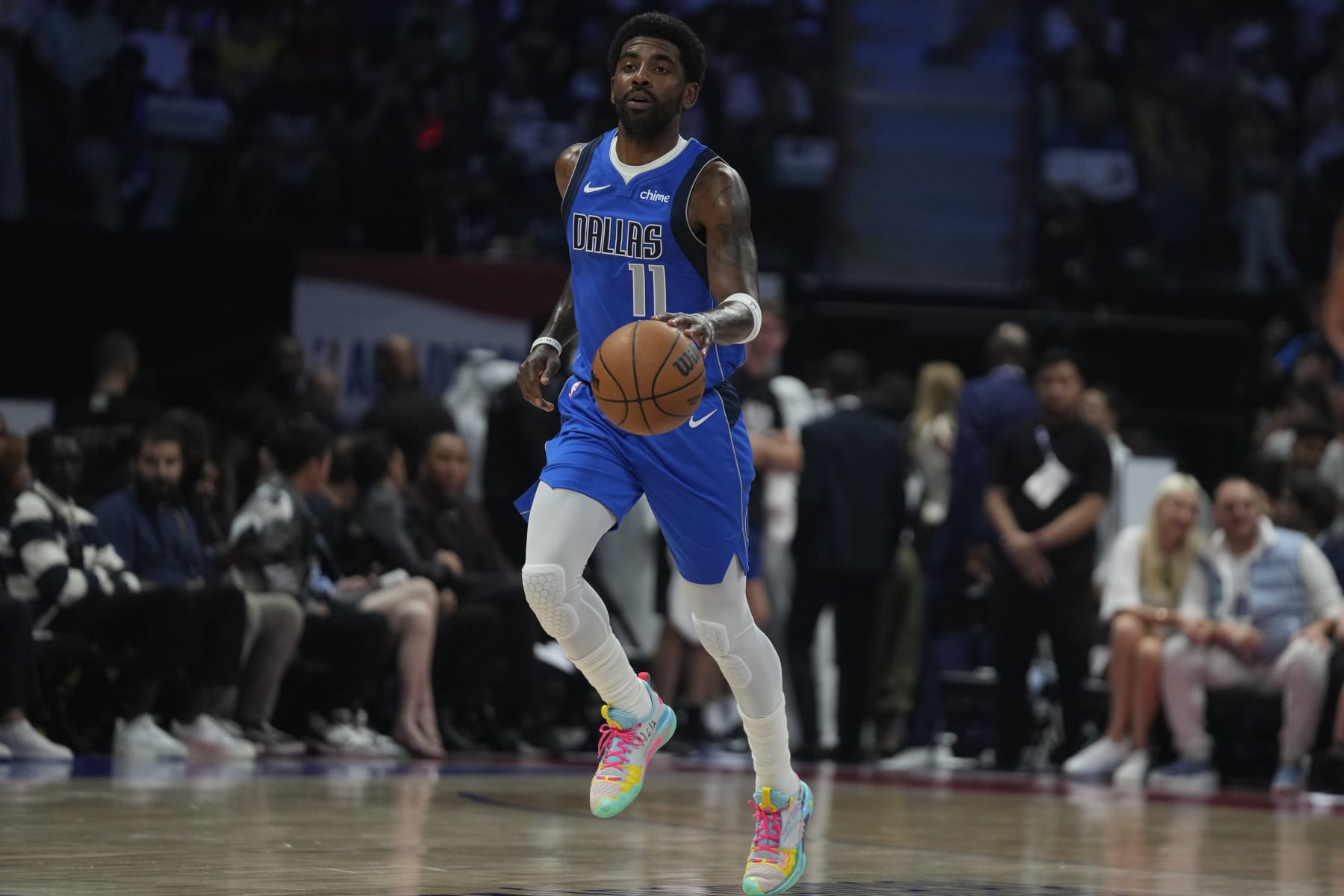 Kyrie Irving of the Dallas Mavericks dribbles during a preseason NBA basketball game between the Dallas Mavericks and Minnesota Timberwolves in Abu Dhabi, United Arab Emirates, Thursday, Oct. 5, 2023. (AP Photo/Kamran Jebreili)