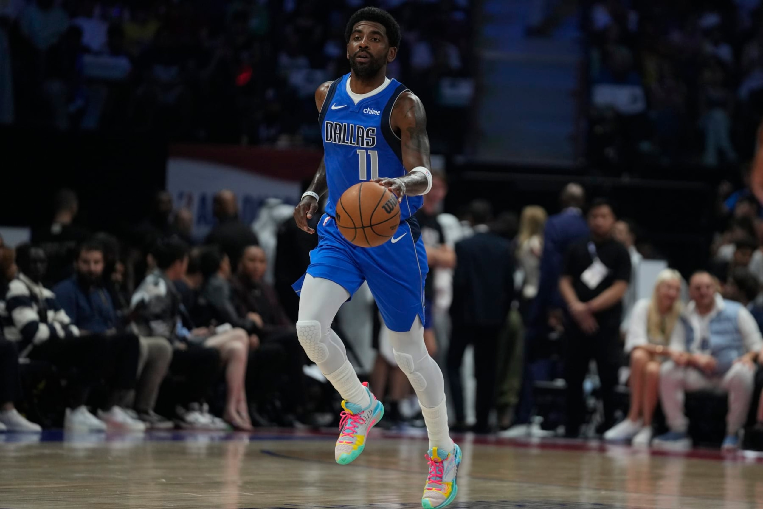 Kyrie Irving of the Dallas Mavericks dribbles during a preseason NBA basketball game between the Dallas Mavericks and Minnesota Timberwolves in Abu Dhabi, United Arab Emirates, Thursday, Oct. 5, 2023. (AP Photo/Kamran Jebreili)