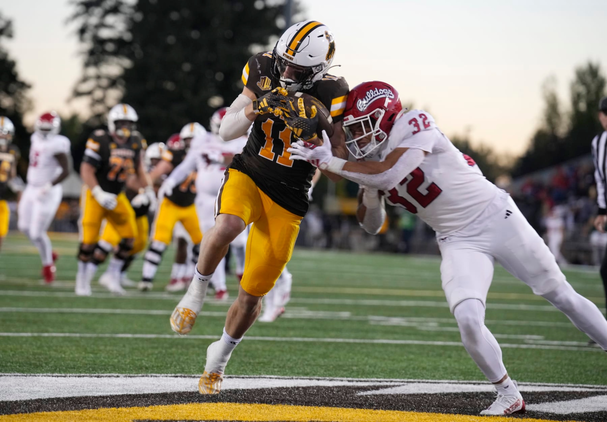 Wyoming wide receiver Wyatt Wieland, left, pulls in a pass for a tocuhdown as Fresno State defensive back Dean Clark covers during the first half of an NCAA college football game Saturday, Oct. 7, 2023, in Laramie, Wyo. (AP Photo/David Zalubowski)