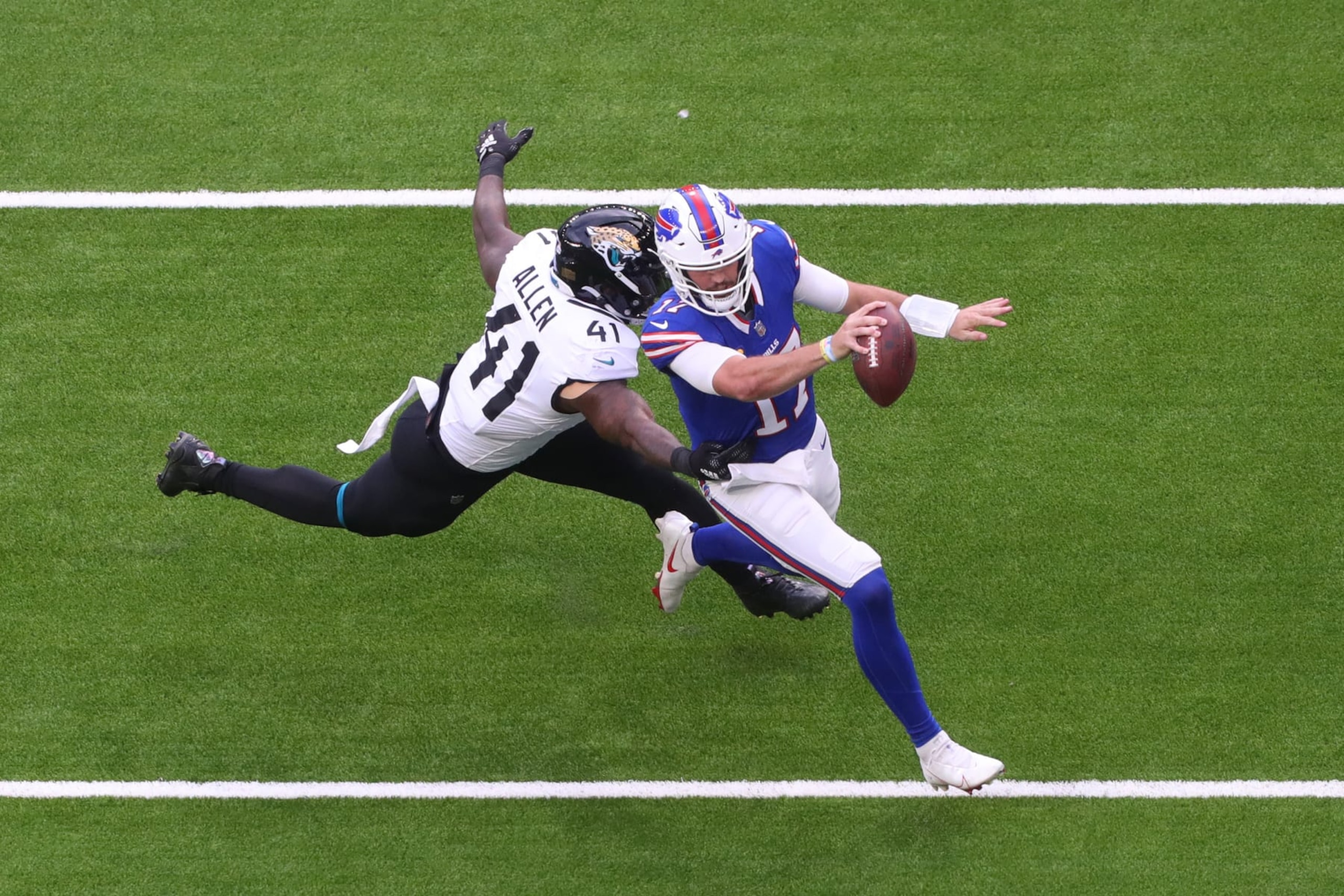 LONDON, ENGLAND - OCTOBER 08: Josh Allen #17 of the Buffalo Bills avoids Josh Allen #41 of the Jacksonville Jaguars in the second Quarter during the NFL Match between Jacksonville Jaguars and Buffalo Bills at Tottenham Hotspur Stadium on October 08, 2023 in London, England. (Photo by Henry Browne/Getty Images)