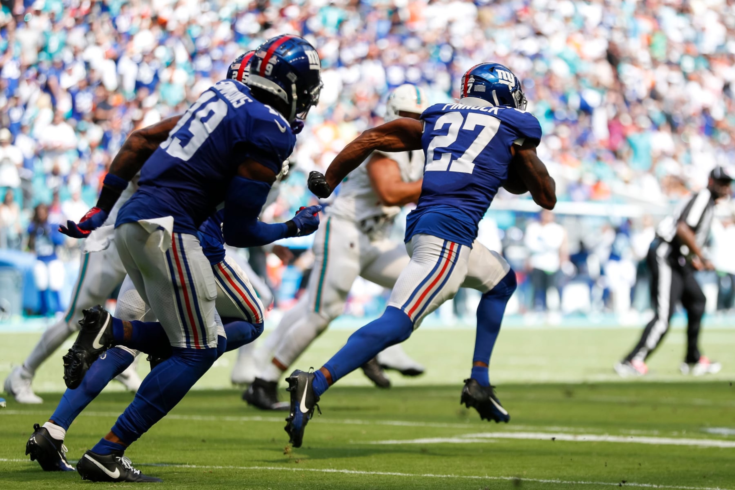 Giants safety Jason Pinnock returns an interception against the Dolphins