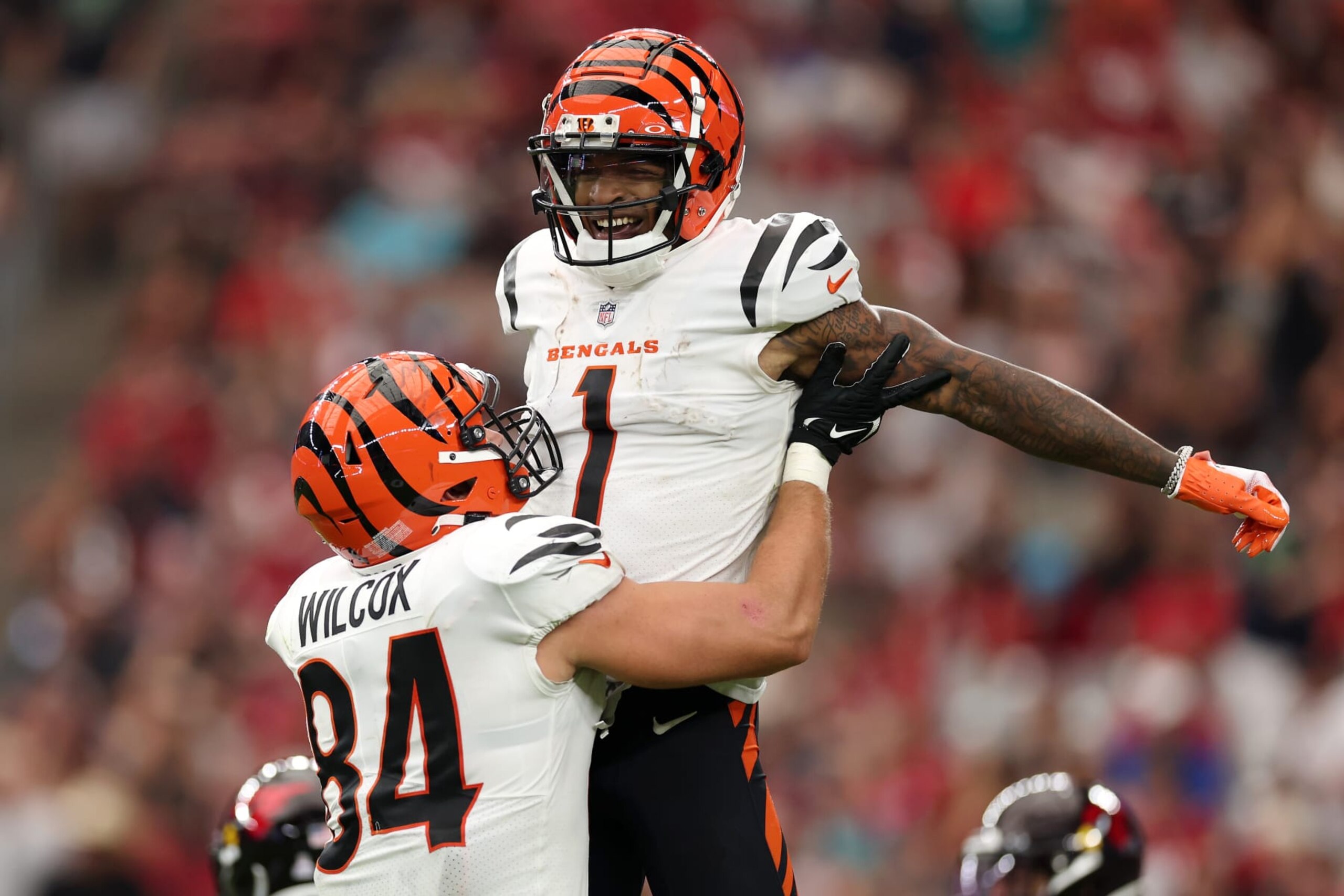 GLENDALE, ARIZONA - OCTOBER 08: Mitchell Wilcox #84 lifts up Ja'Marr Chase #1 of the Cincinnati Bengals after a touchdown catch against the Arizona Cardinals during the third quarter at State Farm Stadium on October 08, 2023 in Glendale, Arizona. (Photo by Christian Petersen/Getty Images)