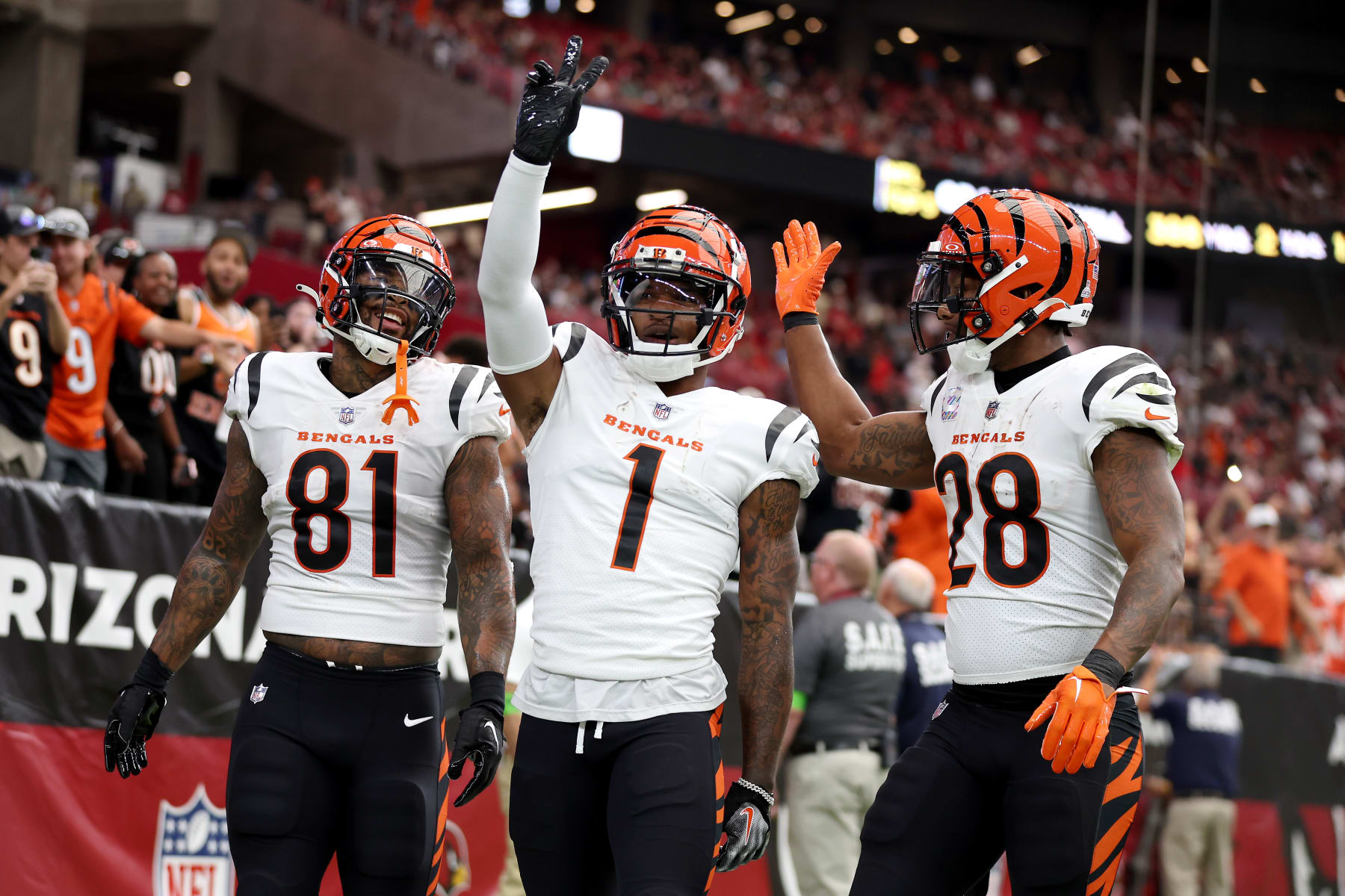 GLENDALE, ARIZONA - OCTOBER 08: Ja'Marr Chase #1 of the Cincinnati Bengals celebrates a touchdown with teammates Joe Mixon #28 and Irv Smith Jr. #81 against the Arizona Cardinals during the first quarter at State Farm Stadium on October 08, 2023 in Glendale, Arizona. (Photo by Christian Petersen/Getty Images)