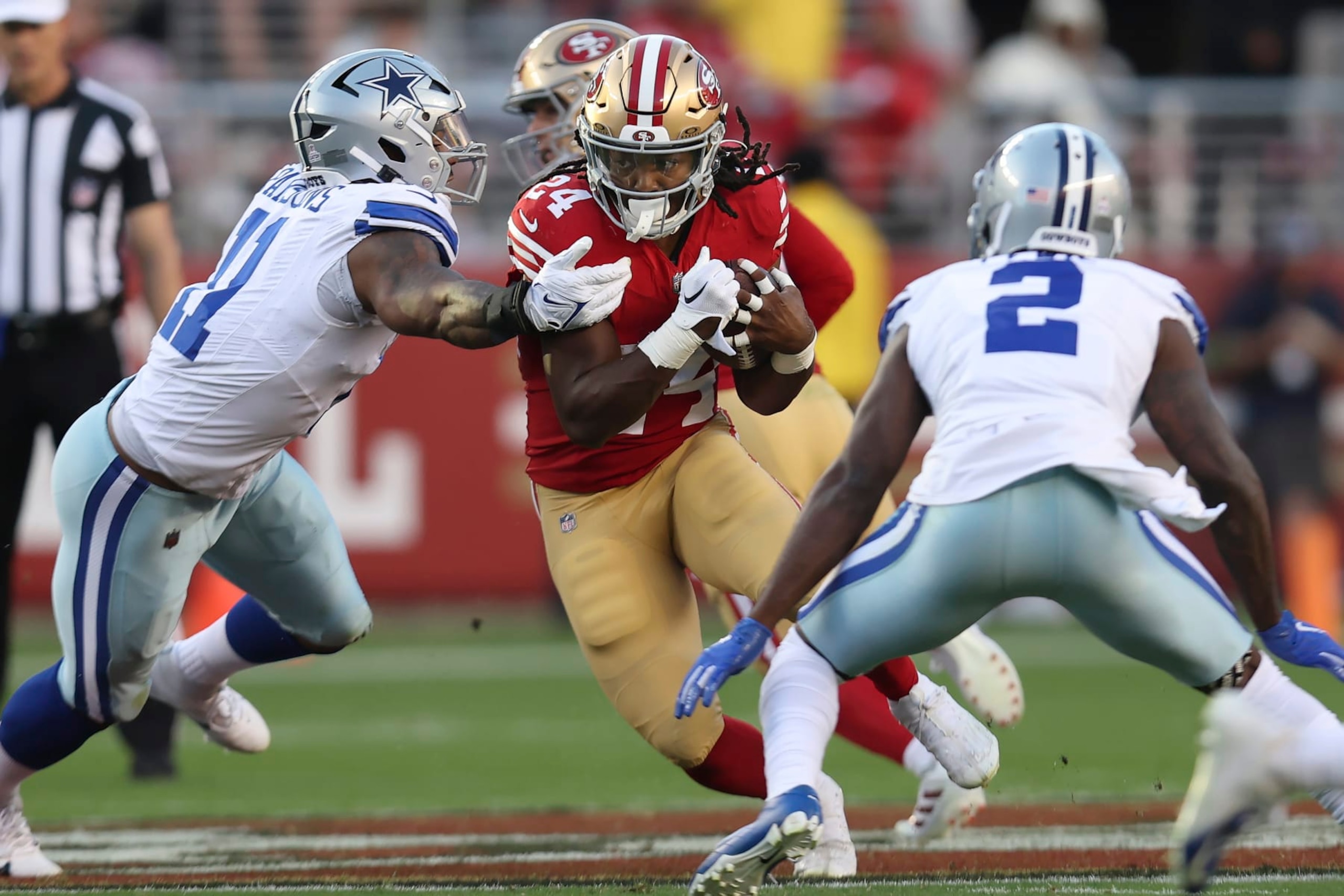 San Francisco 49ers running back Jordan Mason (24) runs between Dallas Cowboys linebacker Micah Parsons, left, and cornerback Jourdan Lewis (2) during the first half of an NFL football game in Santa Clara, Calif., Sunday, Oct. 8, 2023. (AP Photo/Jed Jacobsohn) San Francisco 49ers running back Jordan Mason (24) runs between Dallas Cowboys linebacker Micah Parsons, left, and cornerback Jourdan Lewis (2) during the first half of an NFL football game in Santa Clara, Calif., Sunday, Oct. 8, 2023. (AP Photo/Jed Jacobsohn)
