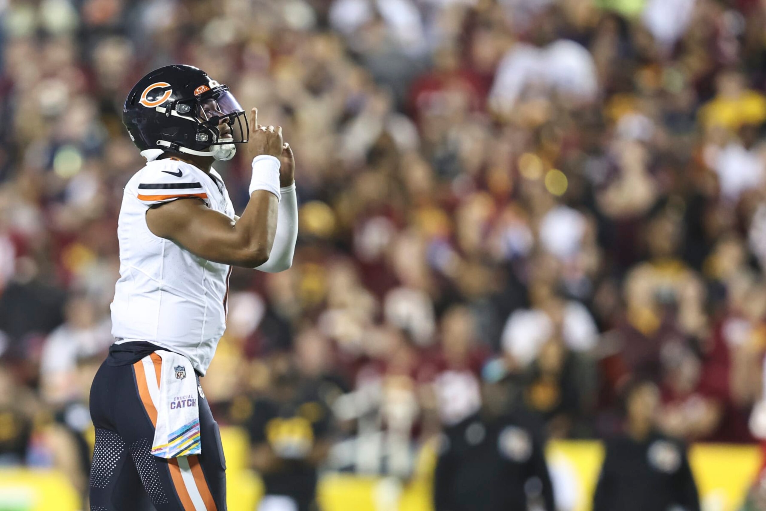 LANDOVER, MARYLAND - OCTOBER 05: Justin Fields #1 of the Chicago Bears celebrates after passing to DJ Moore #2 of the Chicago Bears for a touchdown during an NFL football game between the Washington Commanders and the Chicago Bears at FedExField on October 05, 2023 in Landover, Maryland. (Photo by Michael Owens/Getty Images)