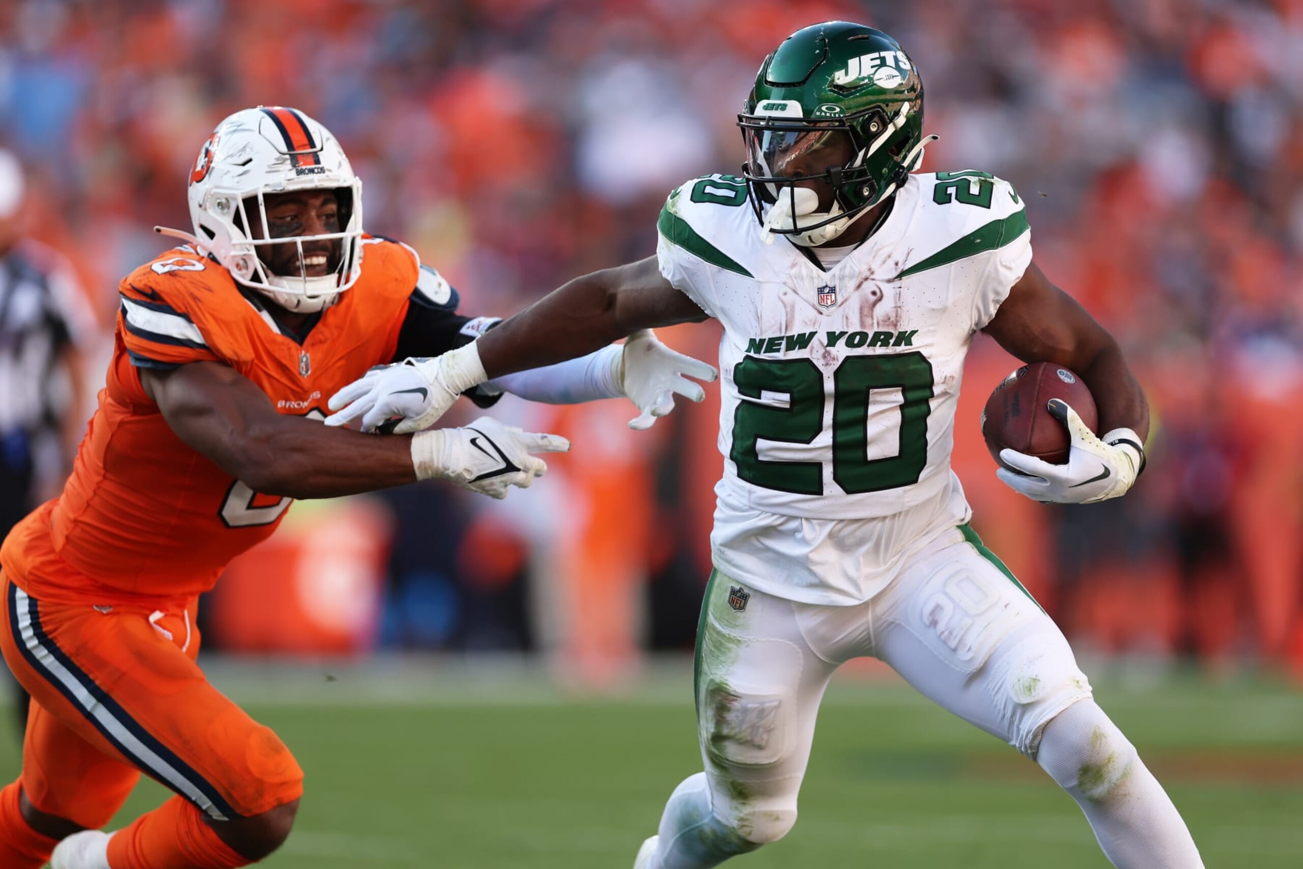 DENVER, COLORADO - OCTOBER 08: Breece Hall #20 of the New York Jets runs with the ball while being chased by Jonathon Cooper #0 of the Denver Broncos in the fourth quarter at Empower Field At Mile High on October 08, 2023 in Denver, Colorado. (Photo by Matthew Stockman/Getty Images)