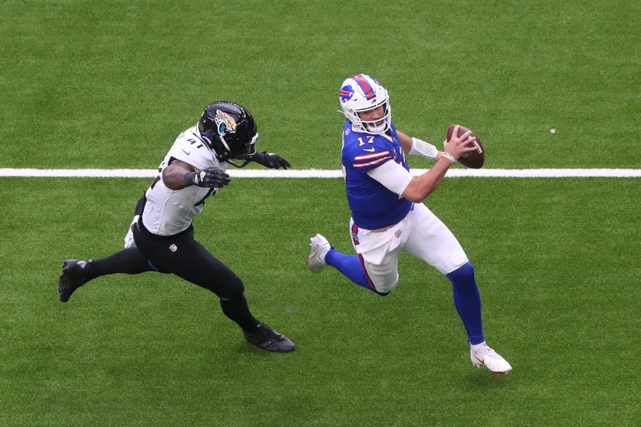 LONDON, ENGLAND - OCTOBER 08: Josh Allen #17 of the Buffalo Bills avoids Josh Allen #41 of the Jacksonville Jaguars in the second Quarter during the NFL Match between Jacksonville Jaguars and Buffalo Bills at Tottenham Hotspur Stadium on October 08, 2023 in London, England. (Photo by Henry Browne/Getty Images) LONDON, ENGLAND - OCTOBER 08: Josh Allen #17 of the Buffalo Bills avoids Josh Allen #41 of the Jacksonville Jaguars in the second Quarter during the NFL Match between Jacksonville Jaguars and Buffalo Bills at Tottenham Hotspur Stadium on October 08, 2023 in London, England. (Photo by Henry Browne/Getty Images)