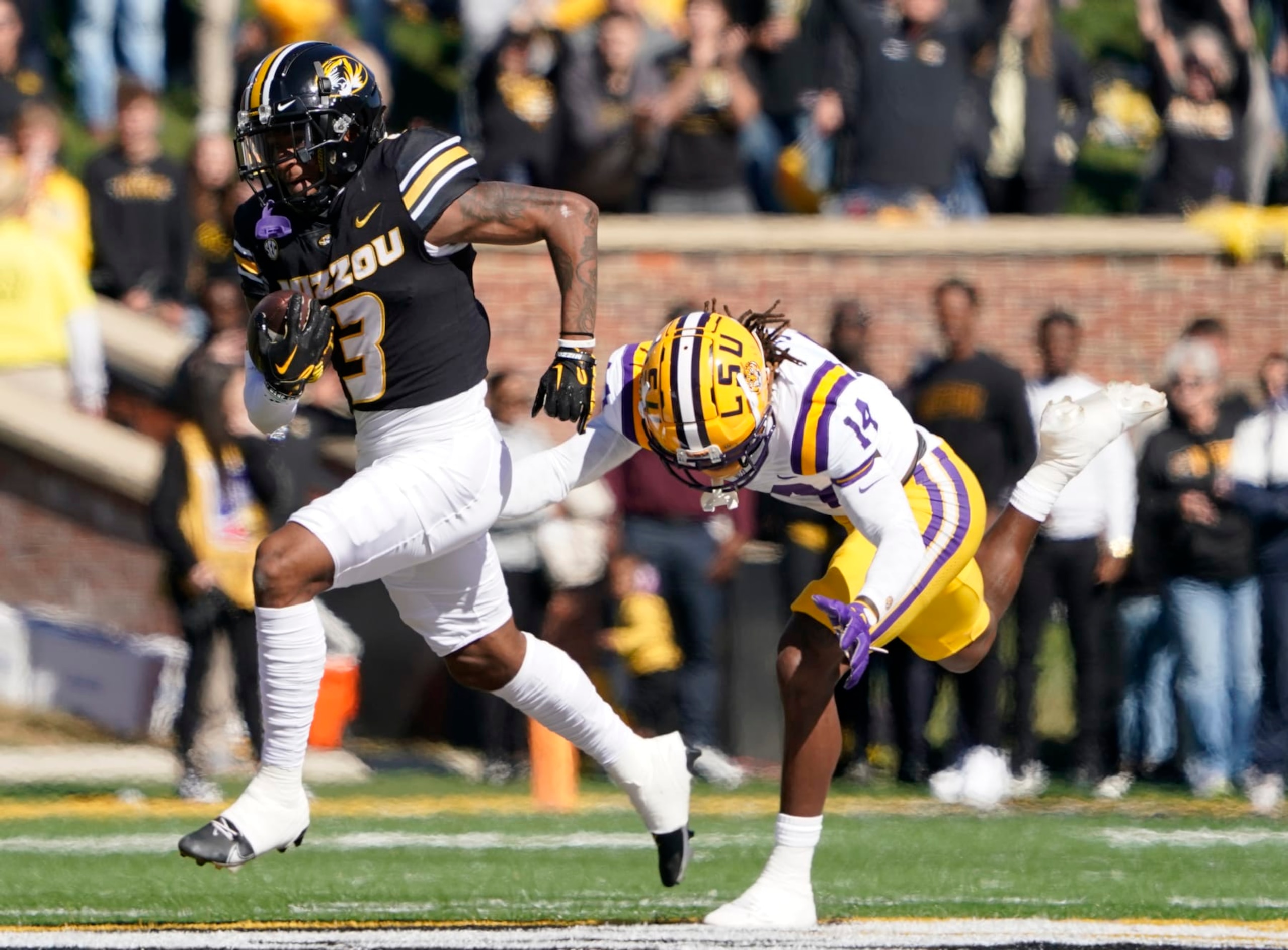 COLUMBIA, MISSOURI - OCTOBER 07: Wide receiver Luther Burden III #3 of the Missouri Tigers runs against safety Andre' Sam #14 of the LSU Tigers in the first half at Faurot Field/Memorial Stadium on October 07, 2023 in Columbia, Missouri. (Photo by Ed Zurga/Getty Images)