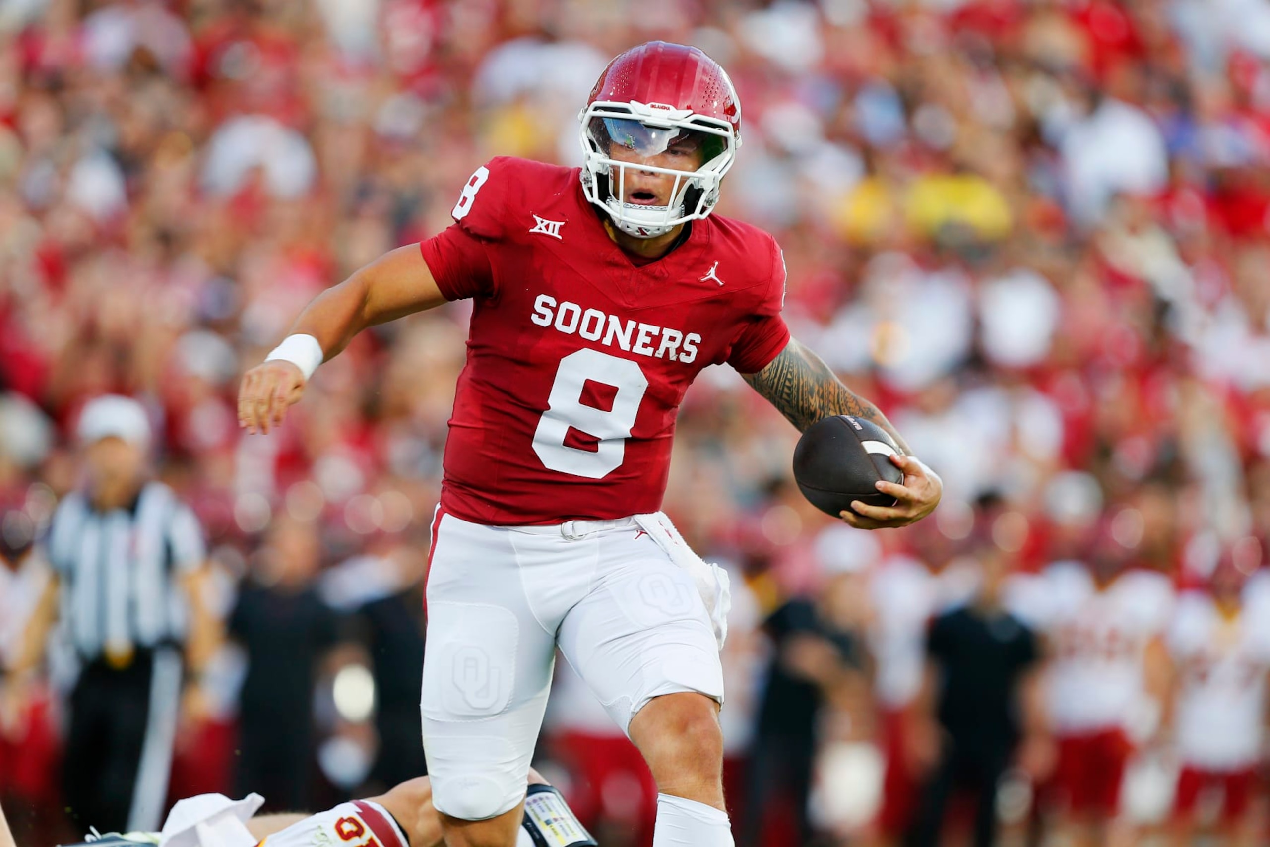 NORMAN, OKLAHOMA - SEPTEMBER 30:  Quarterback Dillon Gabriel #8 of the Oklahoma Sooners breaks past a tackle to score a one-yard touchdown against the Iowa State Cyclones in the first quarter at Gaylord Family Oklahoma Memorial Stadium on September 30, 2023 in Norman, Oklahoma.  Oklahoma won 50-20. (Photo by Brian Bahr/Getty Images)