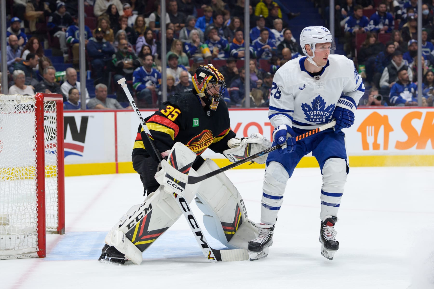 VANCOUVER, CANADA - MARCH 4: Thatcher Demko #35 of the Vancouver Canucks defends against Sam Lafferty #28 of the Toronto Maple Leafs during the second period of their NHL game at Rogers Arena on March 4, 2023 in Vancouver, British Columbia, Canada. (Photo by Derek Cain/Getty Images)