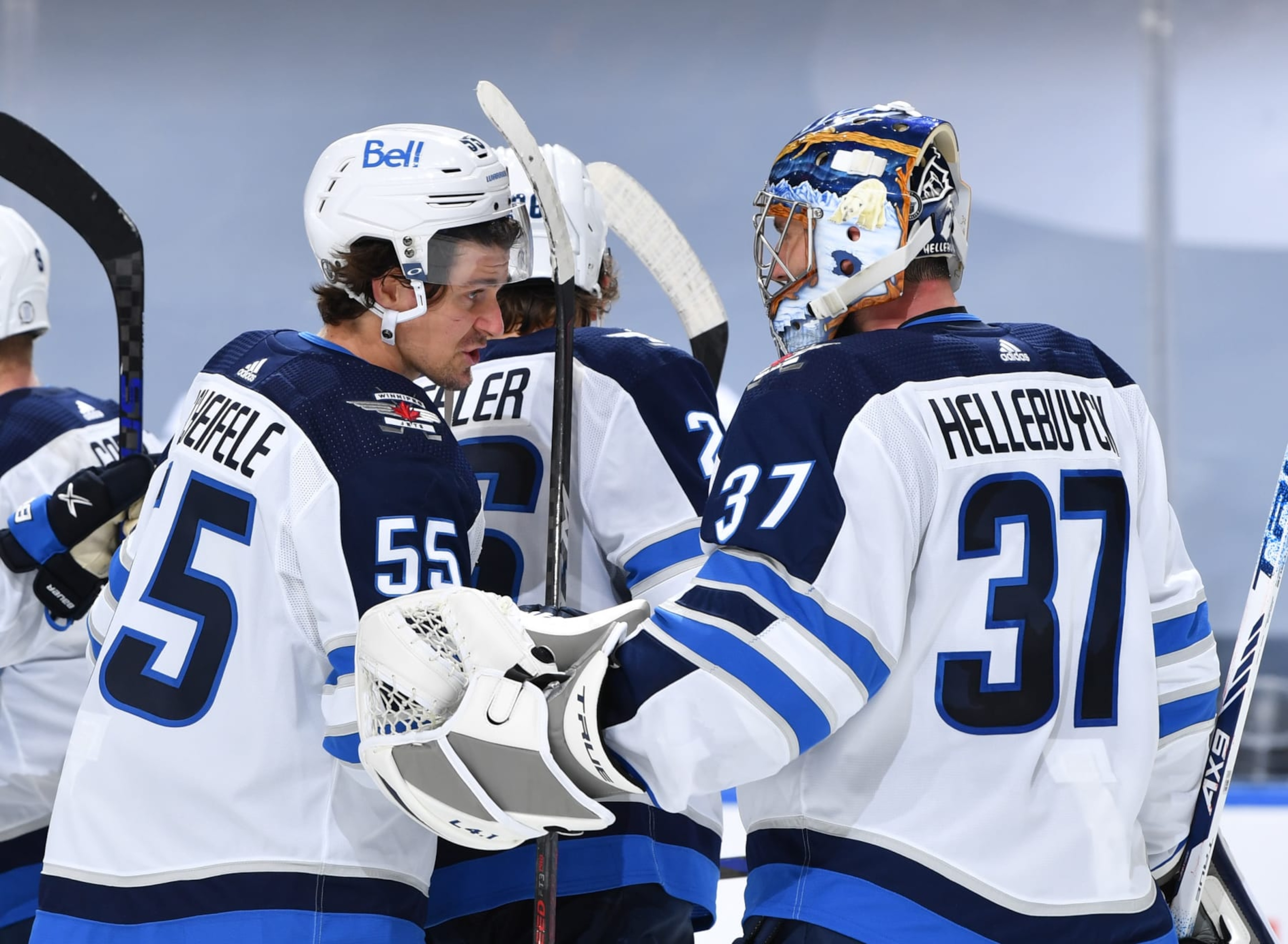 EDMONTON, AB - MAY 19:  Mark Scheifele #55 and Connor Hellebuyck #37 of the Winnipeg Jets celebrate after winning Game One of the First Round of the 2021 Stanley Cup Playoffs against the Edmonton Oilers on May 19, 2021 at Rogers Place in Edmonton, Alberta, Canada. (Photo by Andy Devlin/NHLI via Getty Images)