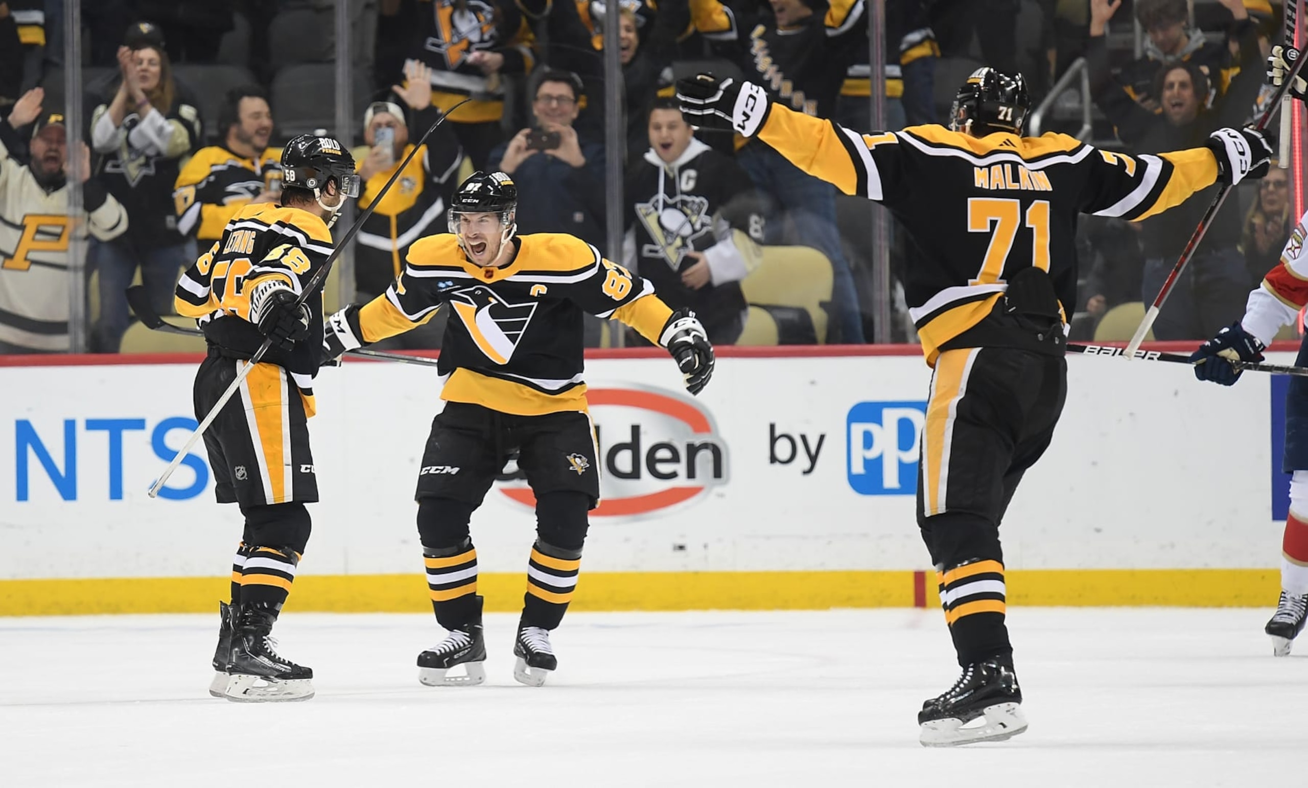 PITTSBURGH, PA - JANUARY 24: Kris Letang #58 of the Pittsburgh Penguins celebrates with teammates, Sidney Crosby #87 and Evgeni Malkin #71, after scoring the game winning goal in overtime to give the Penguins a 7-6 win over the Florida Panthers during the game at PPG PAINTS Arena on January 24, 2023 in Pittsburgh, Pennsylvania. (Photo by Justin Berl/Getty Images) PITTSBURGH, PA - JANUARY 24: Kris Letang #58 of the Pittsburgh Penguins celebrates with teammates, Sidney Crosby #87 and Evgeni Malkin #71, after scoring the game winning goal in overtime to give the Penguins a 7-6 win over the Florida Panthers during the game at PPG PAINTS Arena on January 24, 2023 in Pittsburgh, Pennsylvania. (Photo by Justin Berl/Getty Images)