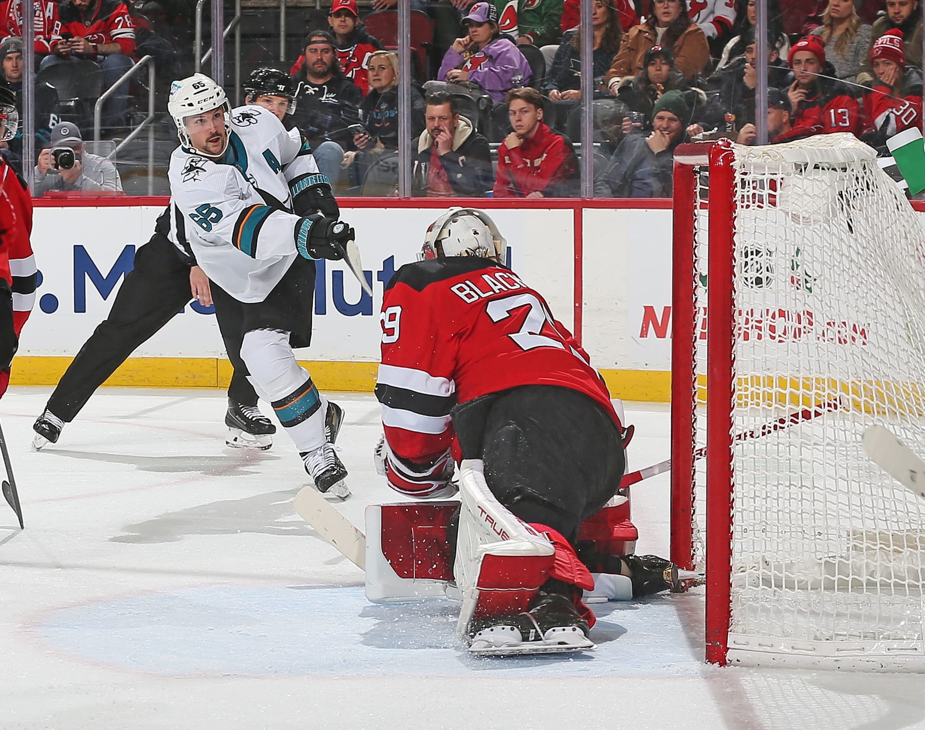 NEWARK, NJ - NOVEMBER 30: Erik Karlsson #65 of the San Jose Sharks scores a second period goal against Mackenzie Blackwood #29 of the New Jersey Devils at the Prudential Center on November 30, 2021 in Newark, New Jersey. The Sharks defeated the Devils 5-2. (Photo by Andy Marlin/NHLI via Getty Images)