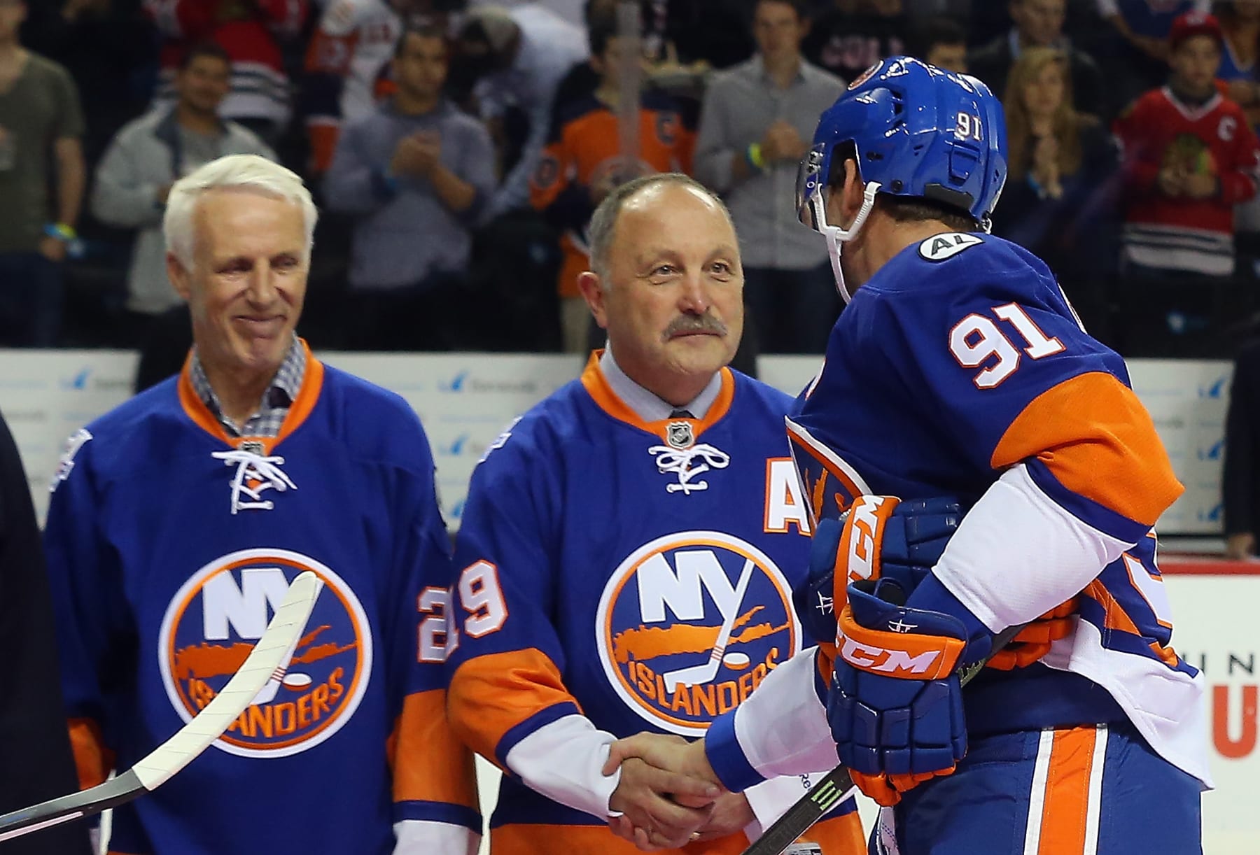 NEW YORK, NY - OCTOBER 09: Mike Bossy and Bryan Trottier shake hands with John Tavares #91 of the New York Islanders during a pregame ceremony prior to playing against the Chicago Blackhawks at the Barclays Center on October 9, 2015 in Brooklyn borough of New York City. The game is the first for the Islanders in their new arena.  (Photo by Bruce Bennett/Getty Images)