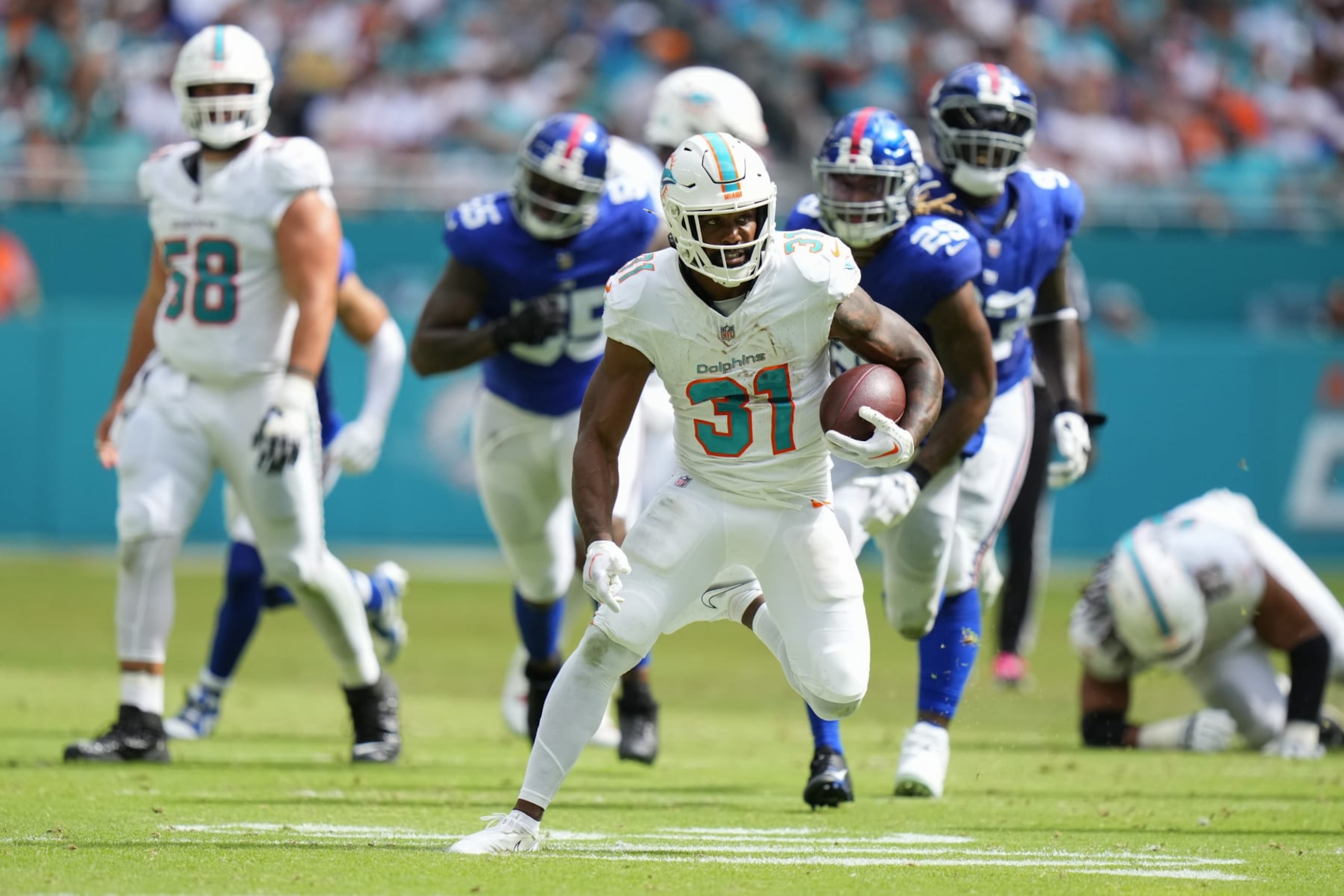 MIAMI GARDENS, FLORIDA - OCTOBER 08: Raheem Mostert #31 of the Miami Dolphins runs the ball against the New York Giants during the second half at Hard Rock Stadium on October 08, 2023 in Miami Gardens, Florida. (Photo by Rich Storry/Getty Images)