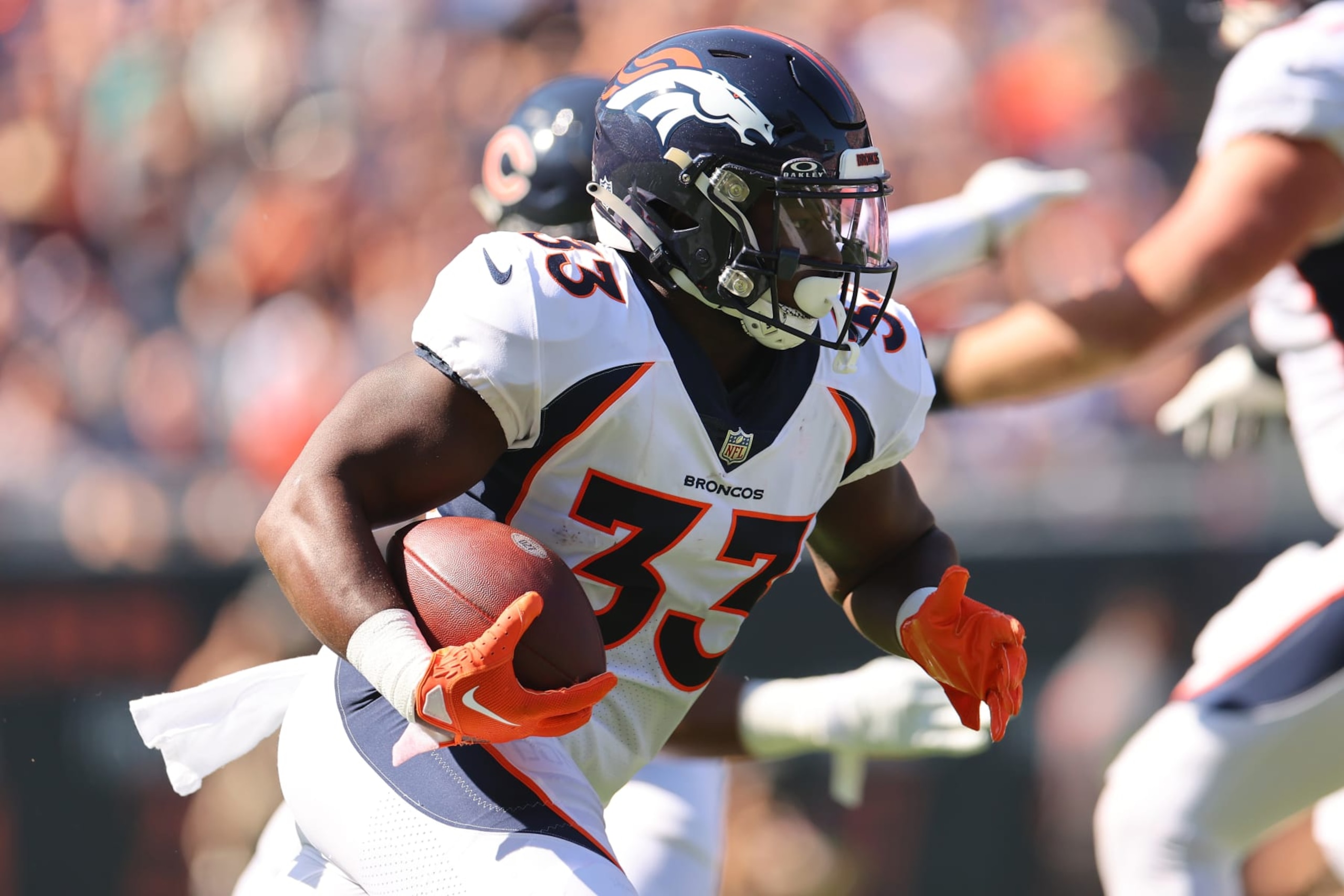 CHICAGO, ILLINOIS - OCTOBER 01: Javonte Williams #33 of the Denver Broncos runs with the ball during the first quarter against the Chicago Bears at Soldier Field on October 01, 2023 in Chicago, Illinois. (Photo by Michael Reaves/Getty Images)