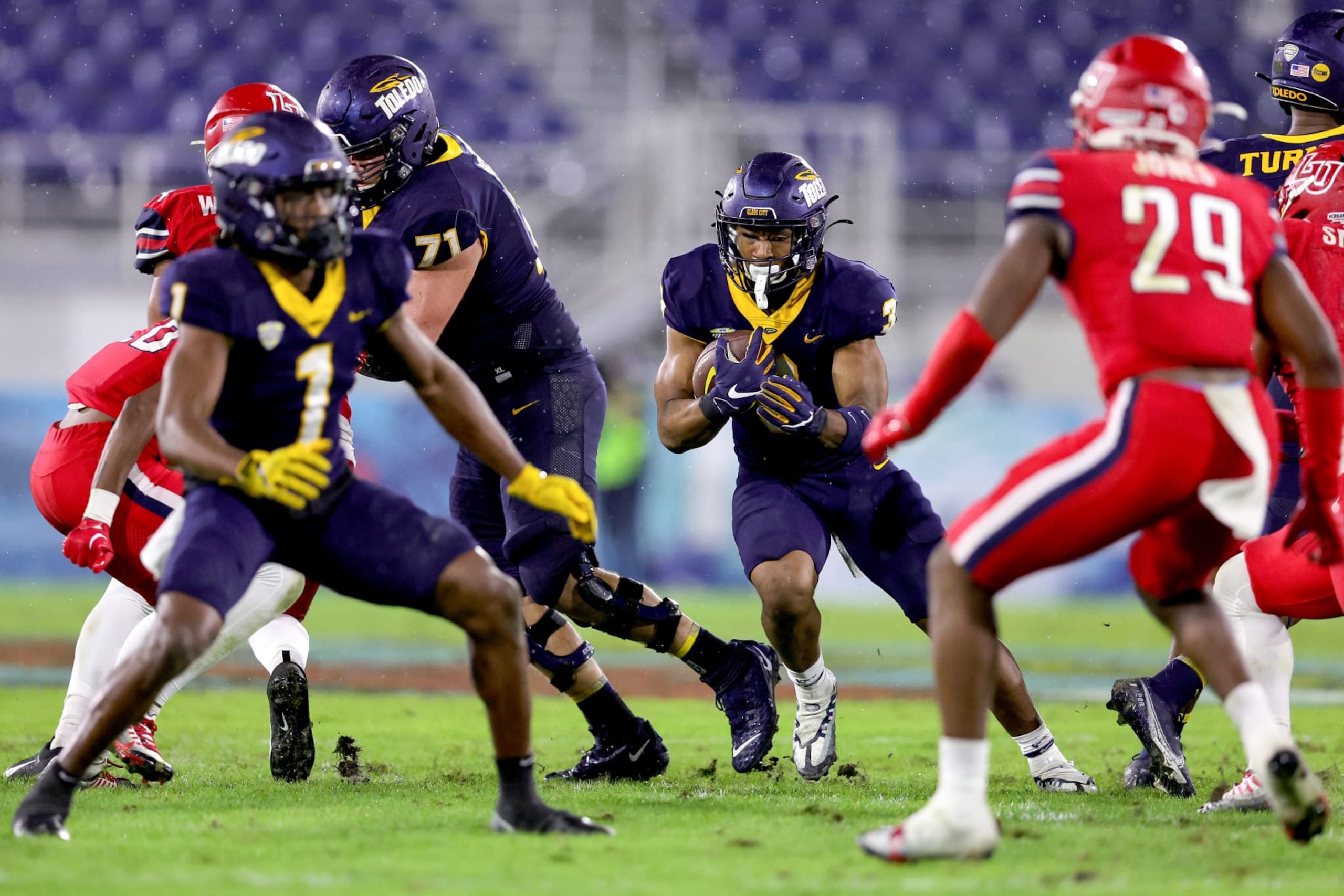 BOCA RATON, FLORIDA - DECEMBER 20: Micah Kelly #3 of the Toledo Rockets carries the ball against the Liberty Flames during the second half of the game during the RoofClaim.com Boca Raton Bowl at FAU Stadium on December 20, 2022 in Boca Raton, Florida. (Photo by Megan Briggs/Getty Images) BOCA RATON, FLORIDA - DECEMBER 20: Micah Kelly #3 of the Toledo Rockets carries the ball against the Liberty Flames during the second half of the game during the RoofClaim.com Boca Raton Bowl at FAU Stadium on December 20, 2022 in Boca Raton, Florida. (Photo by Megan Briggs/Getty Images)