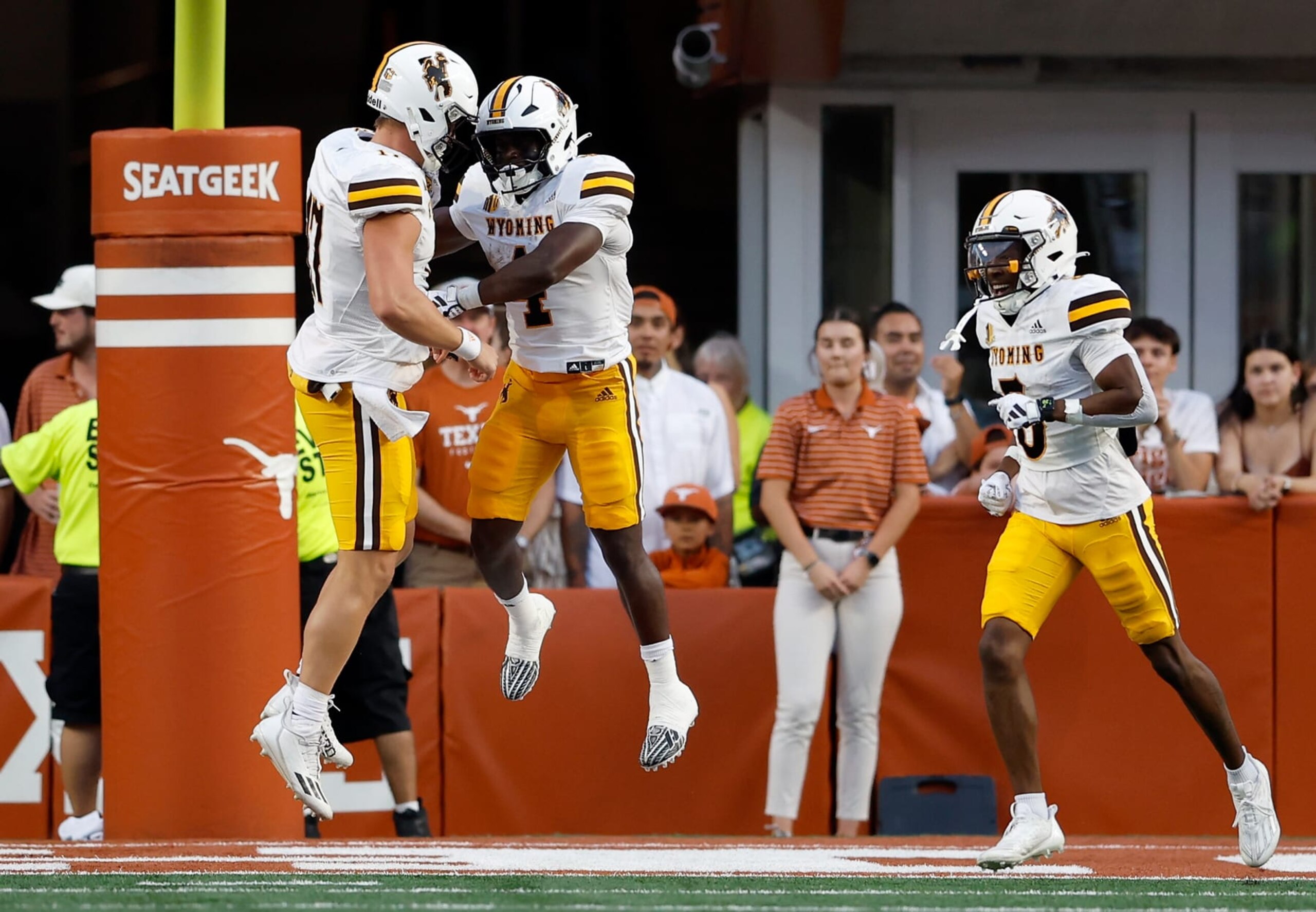 AUSTIN, TEXAS - SEPTEMBER 16: Harrison Waylee #4 of the Wyoming Cowboys is congratulated by Evan Svoboda #17 after a rushing touchdown in the first quarter against the Texas Longhorns at Darrell K Royal-Texas Memorial Stadium on September 16, 2023 in Austin, Texas. (Photo by Tim Warner/Getty Images)