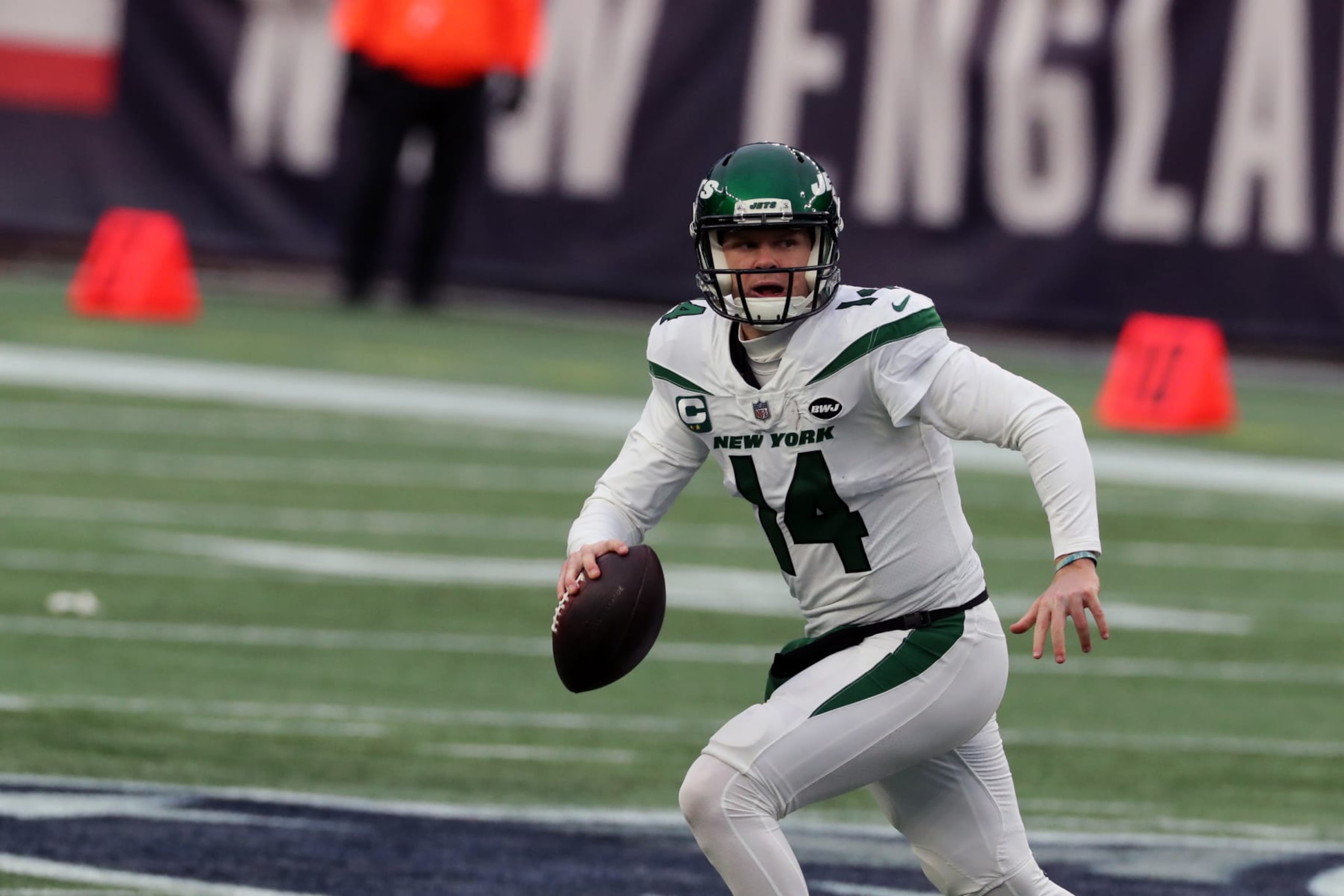 FOXBOROUGH, MA - JANUARY 03: Sam Darnold #14 of the New York Jets carries the ball against the New England Patriots at Gillette Stadium on January 3, 2021 in Foxborough, Massachusetts. (Photo by Al Pereira/Getty Images)