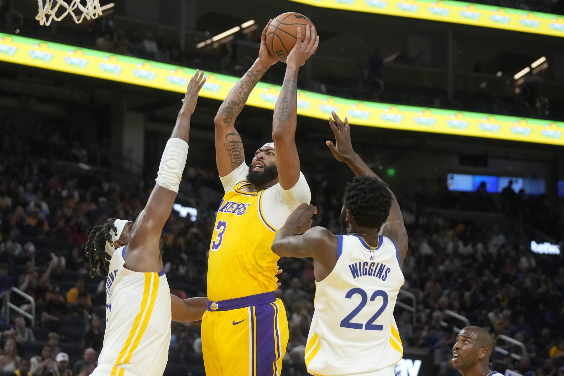 Los Angeles Lakers forward Anthony Davis (3) shoots against Golden State Warriors forwards Kevon Looney, left, and Andrew Wiggins (22) during the first half of an NBA preseason basketball game in San Francisco, Saturday, Oct. 7, 2023. (AP Photo/Jeff Chiu) Los Angeles Lakers forward Anthony Davis (3) shoots against Golden State Warriors forwards Kevon Looney, left, and Andrew Wiggins (22) during the first half of an NBA preseason basketball game in San Francisco, Saturday, Oct. 7, 2023. (AP Photo/Jeff Chiu)