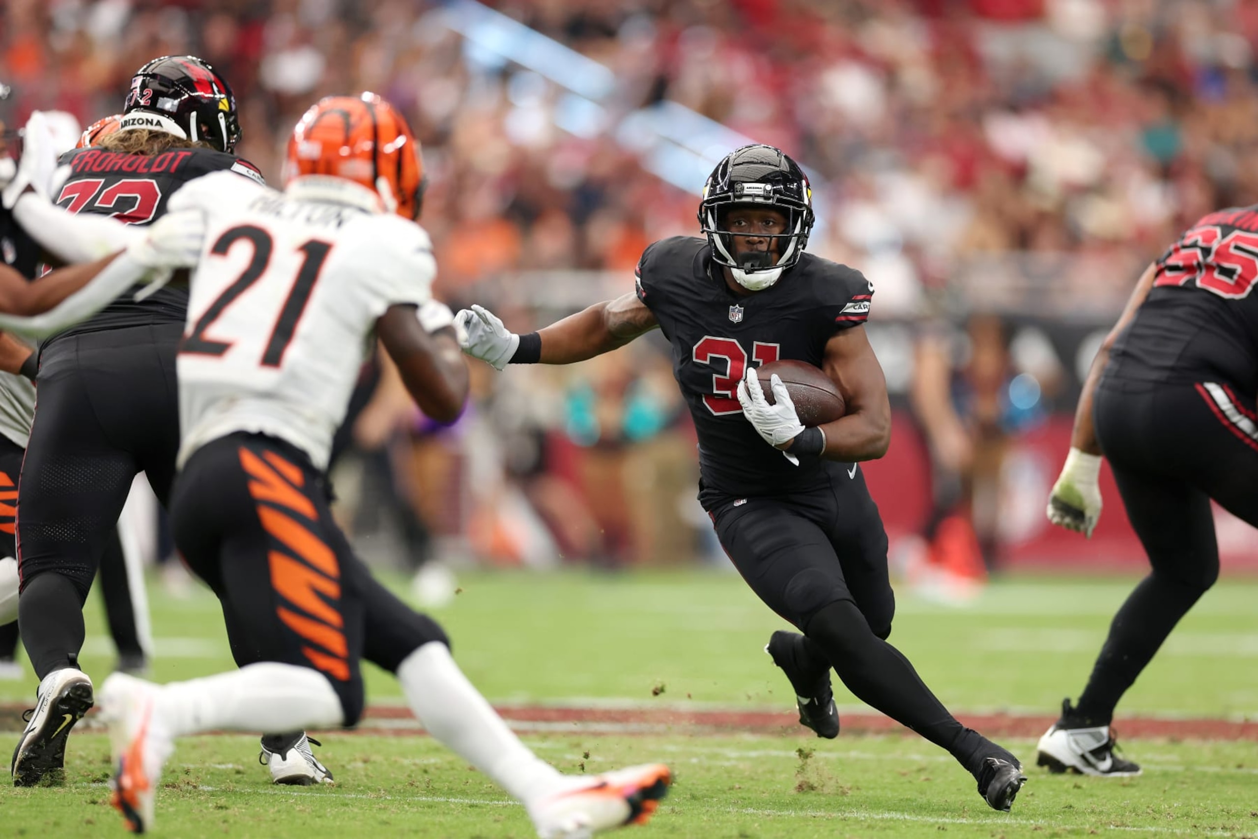 GLENDALE, ARIZONA - OCTOBER 08: Emari Demercado #31 of the Arizona Cardinals runs the ball against the Cincinnati Bengals during the third quarter at State Farm Stadium on October 08, 2023 in Glendale, Arizona. (Photo by Christian Petersen/Getty Images)