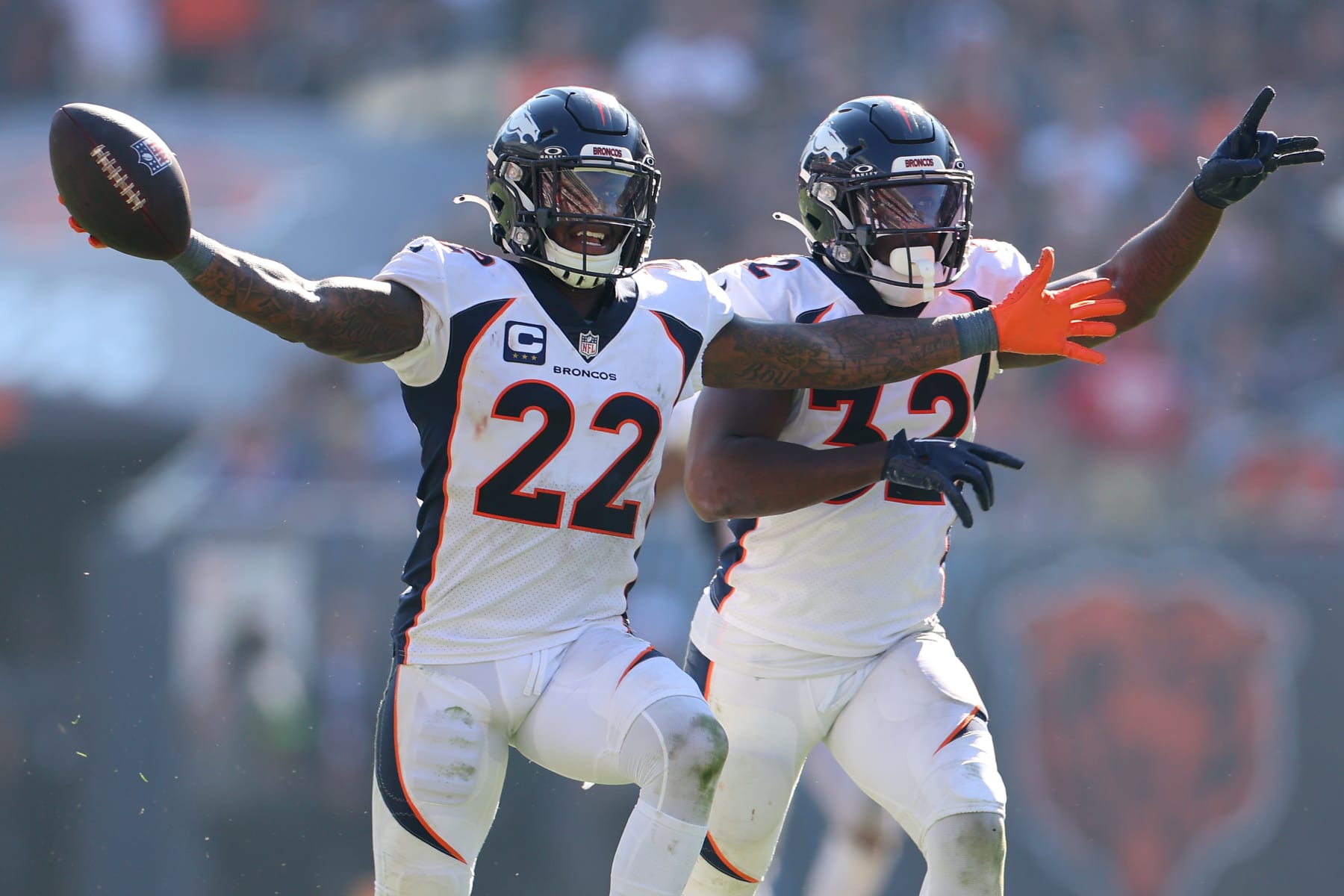 CHICAGO, ILLINOIS - OCTOBER 01: Kareem Jackson #22 and Delarrin Turner-Yell #32 of the Denver Broncos celebrate during the second half against the Chicago Bears at Soldier Field on October 01, 2023 in Chicago, Illinois. (Photo by Michael Reaves/Getty Images)