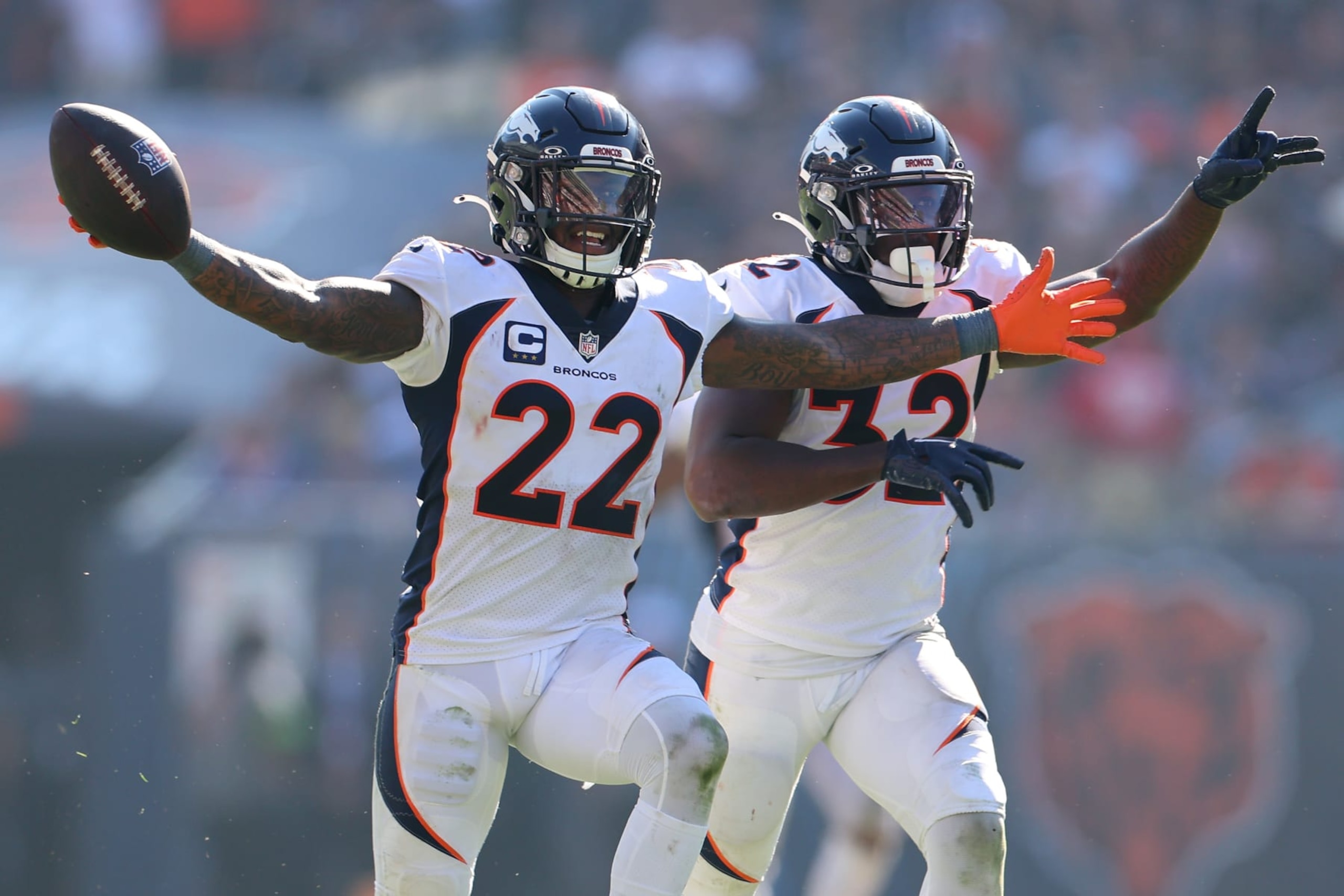 CHICAGO, ILLINOIS - OCTOBER 01: Kareem Jackson #22 and Delarrin Turner-Yell #32 of the Denver Broncos celebrate during the second half against the Chicago Bears at Soldier Field on October 01, 2023 in Chicago, Illinois. (Photo by Michael Reaves/Getty Images)