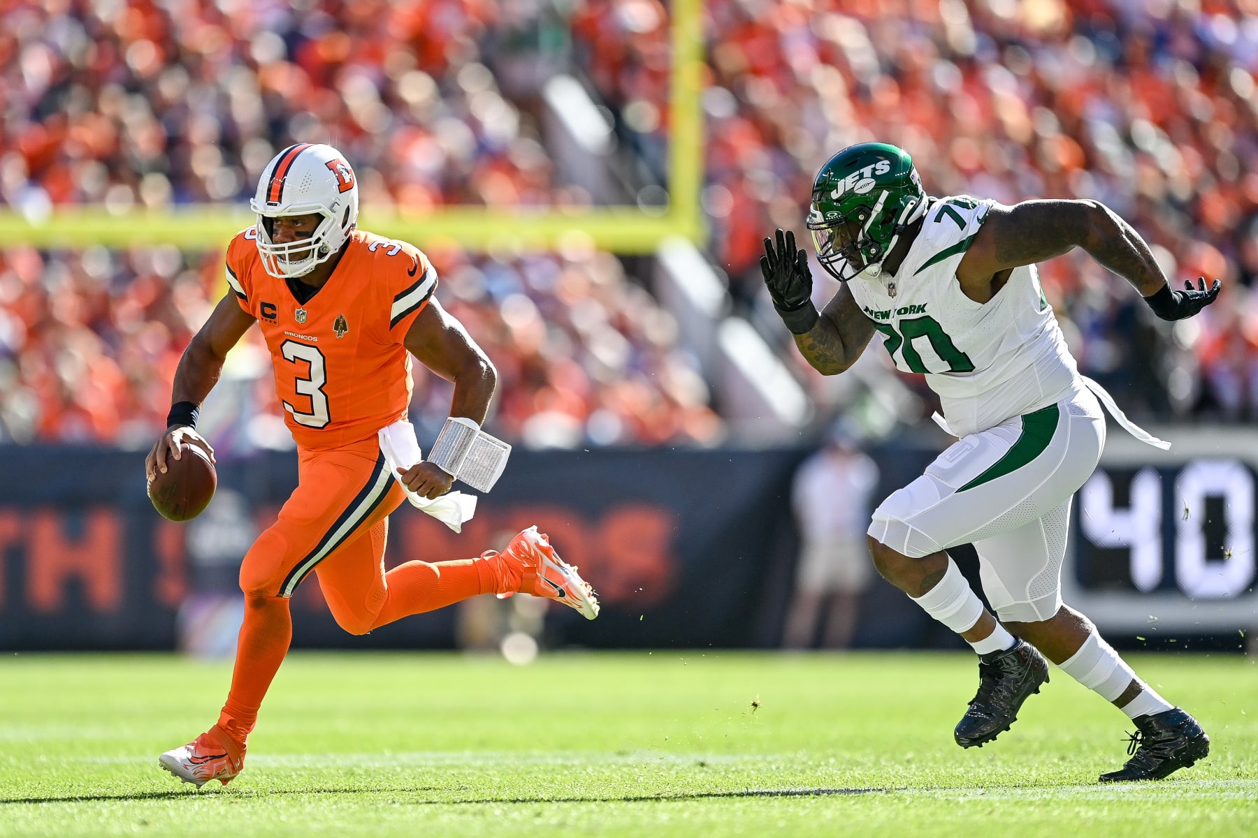 DENVER, CO - OCTOBER 8: Denver Broncos quarterback Russell Wilson (3) scrambles in the first quarter during a game between the New York Jets and the Denver Broncos at Empower Field at Mile High on October 8, 2023 in Denver, Colorado. (Photo by Dustin Bradford/Icon Sportswire via Getty Images)