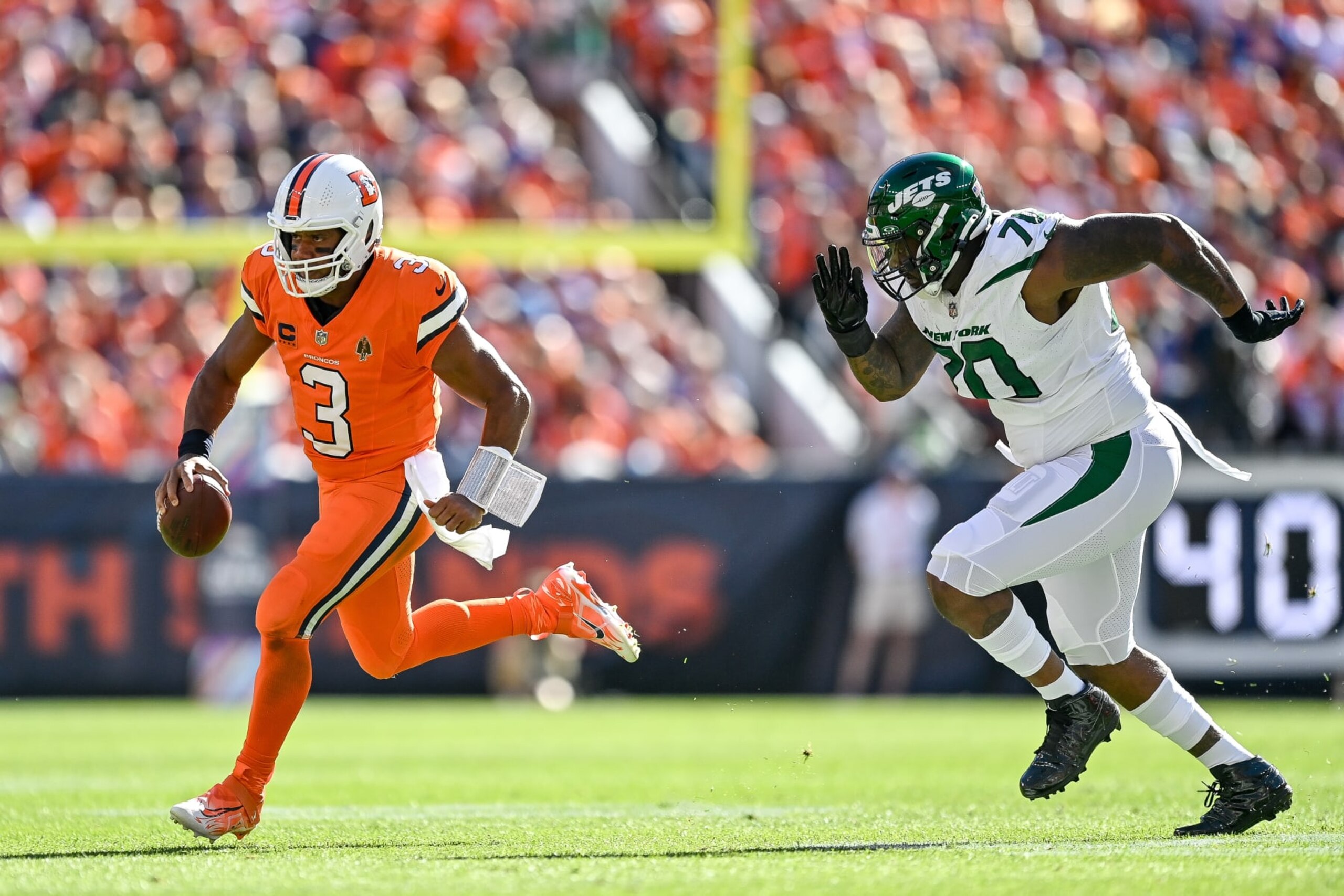 DENVER, CO - OCTOBER 8: Denver Broncos quarterback Russell Wilson (3) scrambles in the first quarter during a game between the New York Jets and the Denver Broncos at Empower Field at Mile High on October 8, 2023 in Denver, Colorado. (Photo by Dustin Bradford/Icon Sportswire via Getty Images)