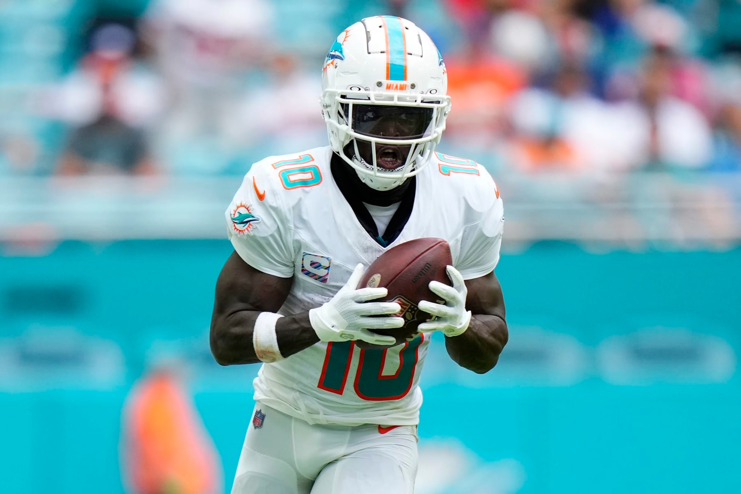 MIAMI GARDENS, FLORIDA - OCTOBER 08: Tyreek Hill #10 of the Miami Dolphins runs the ball against the New York Giants during the third quarter at Hard Rock Stadium on October 08, 2023 in Miami Gardens, Florida. (Photo by Rich Storry/Getty Images)