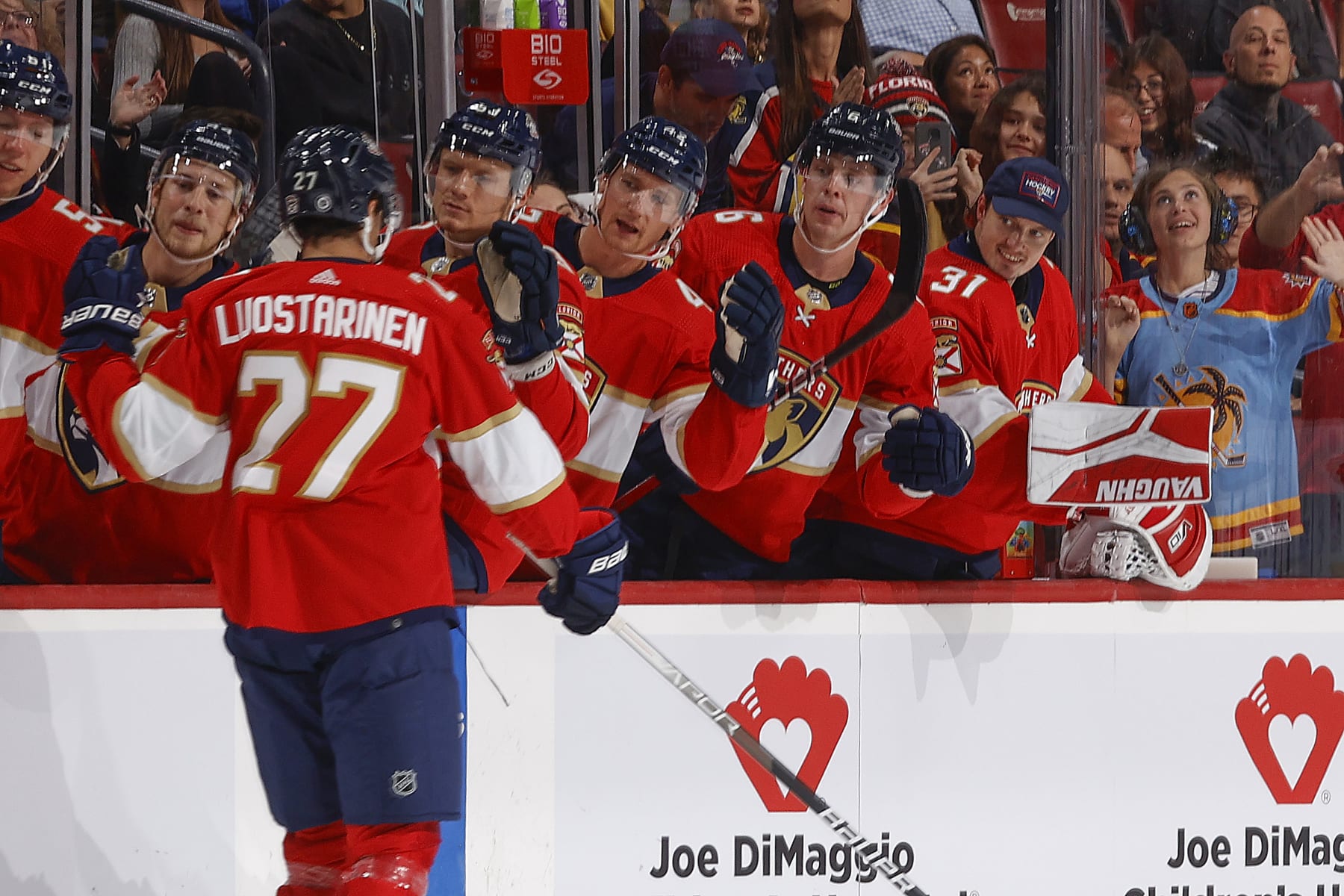 SUNRISE, FL - SEPTEMBER 25: Teammates congratulate Eetu Luostarinen #27 of the Florida Panthers after he scored a first period goal against the Nashville Predators during a preseason game at the Amerant Bank Arena on September 25, 2023 in Sunrise, Florida. (Photo by Joel Auerbach/Getty Images)