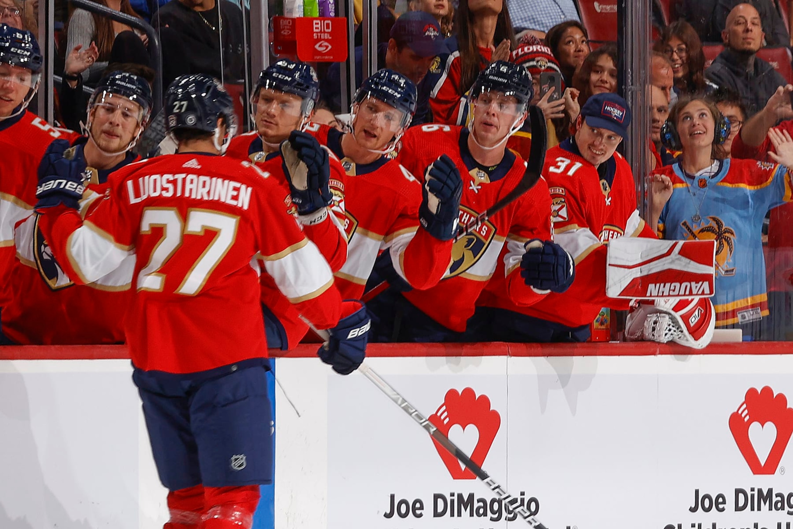 SUNRISE, FL - SEPTEMBER 25: Teammates congratulate Eetu Luostarinen #27 of the Florida Panthers after he scored a first period goal against the Nashville Predators during a preseason game at the Amerant Bank Arena on September 25, 2023 in Sunrise, Florida. (Photo by Joel Auerbach/Getty Images) SUNRISE, FL - SEPTEMBER 25: Teammates congratulate Eetu Luostarinen #27 of the Florida Panthers after he scored a first period goal against the Nashville Predators during a preseason game at the Amerant Bank Arena on September 25, 2023 in Sunrise, Florida. (Photo by Joel Auerbach/Getty Images)