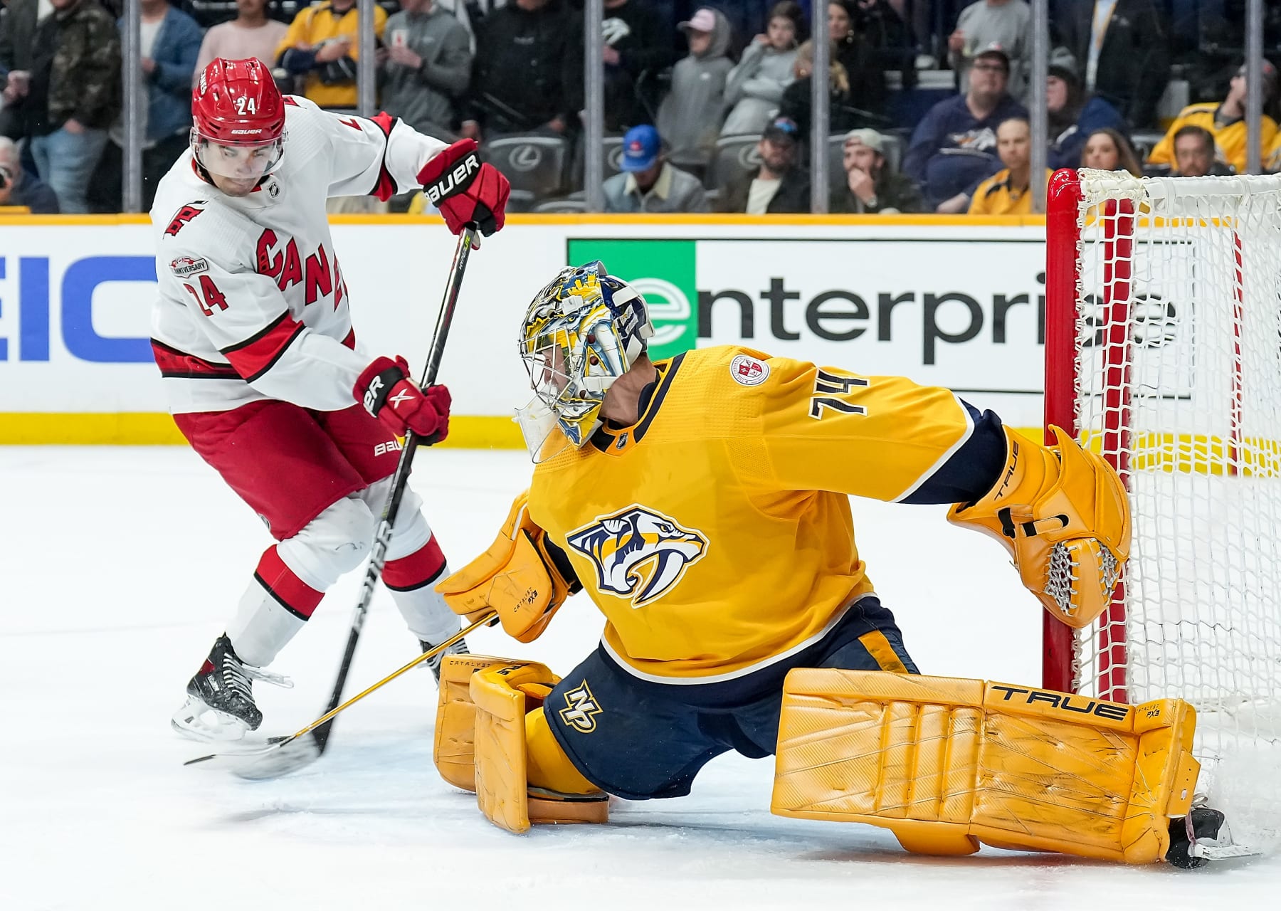NASHVILLE, TENNESSEE - APRIL 6: Juuse Saros #74 of the Nashville Predators makes the save against Seth Jarvis #24 of the Carolina Hurricanes during an NHL game at Bridgestone Arena on April 6, 2023 in Nashville, Tennessee. (Photo by John Russell/NHLI via Getty Images)