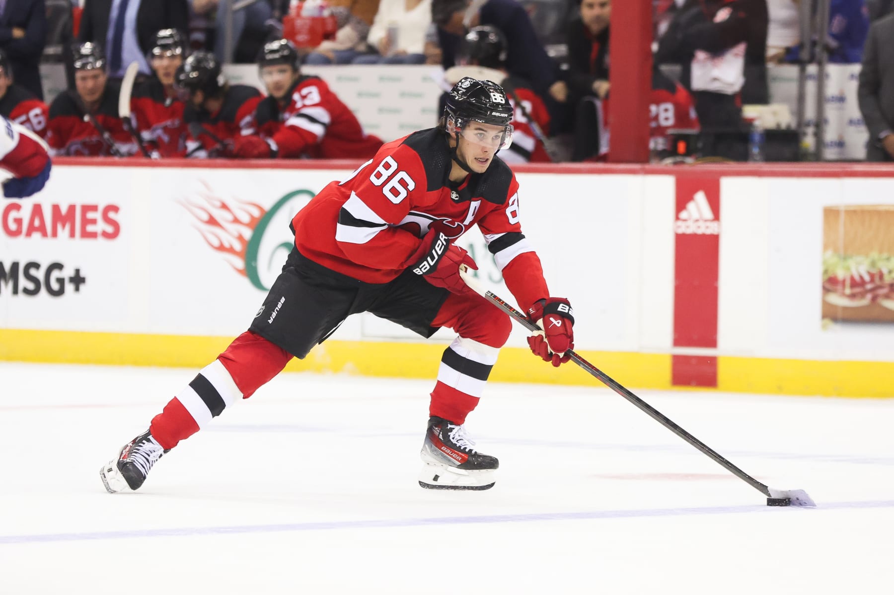 NEWARK, NJ - OCTOBER 04: New Jersey Devils center Jack Hughes (86) skates with the puck during a preseason game between the New York Rangers and New Jersey Devils on October 4, 2023 at Prudential Center in the Newark, New Jersey.(Photo by Andrew Mordzynski/Icon Sportswire via Getty Images)