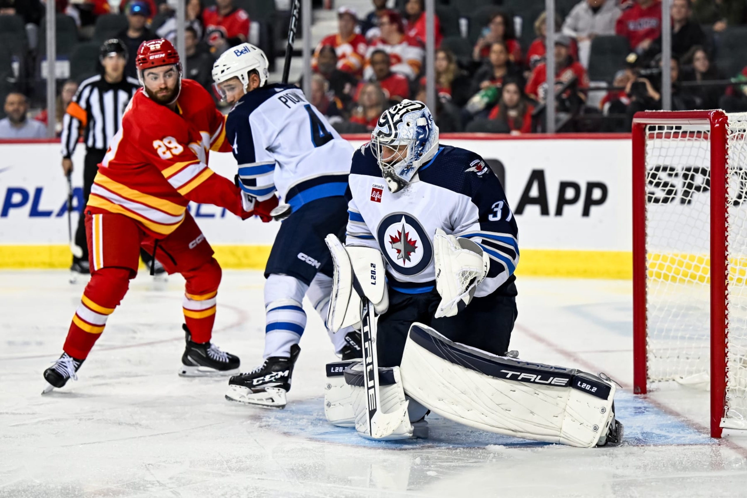 CALGARY, AB - OCTOBER 02: Winnipeg Jets Goalie Connor Hellebuyck (37) tries to stop the puck during the third period of an NHL preseason game between the Calgary Flames and the Winnipeg Jets on October 2, 2023, at the Scotiabank Saddledome in Calgary, AB. (Photo by Brett Holmes/Icon Sportswire via Getty Images) CALGARY, AB - OCTOBER 02: Winnipeg Jets Goalie Connor Hellebuyck (37) tries to stop the puck during the third period of an NHL preseason game between the Calgary Flames and the Winnipeg Jets on October 2, 2023, at the Scotiabank Saddledome in Calgary, AB. (Photo by Brett Holmes/Icon Sportswire via Getty Images)