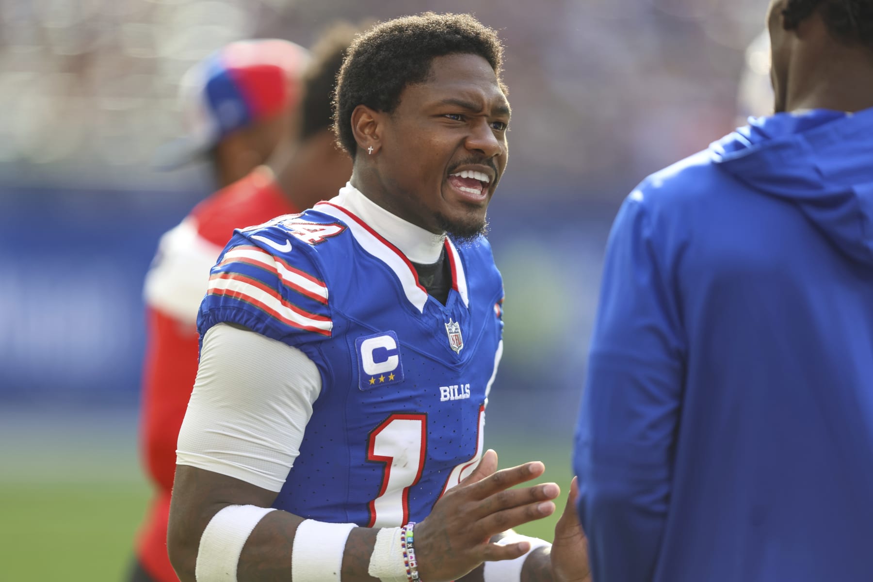 Buffalo Bills wide receiver Stefon Diggs (14) talks with a teammate during an NFL football game against the Jacksonville Jaguars, Sunday, Oct. 8, 2023, in London. (AP/Gary McCullough)