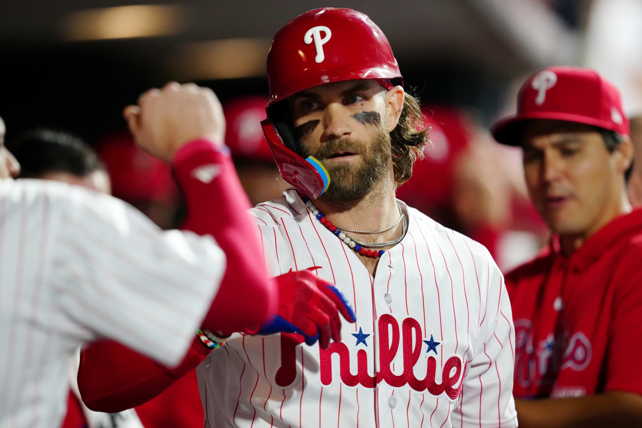 PHILADELPHIA, PA - OCTOBER 11:  Bryce Harper #3 of the Philadelphia Phillies celebrates with teammates in the dugout after hitting a solo home run in the fifth inning during Game 3 of the Division Series between the Atlanta Braves and the Philadelphia Phillies at Citizens Bank Park on Wednesday, October 11, 2023 in Philadelphia, Pennsylvania. (Photo by Mary DeCicco/MLB Photos via Getty Images)