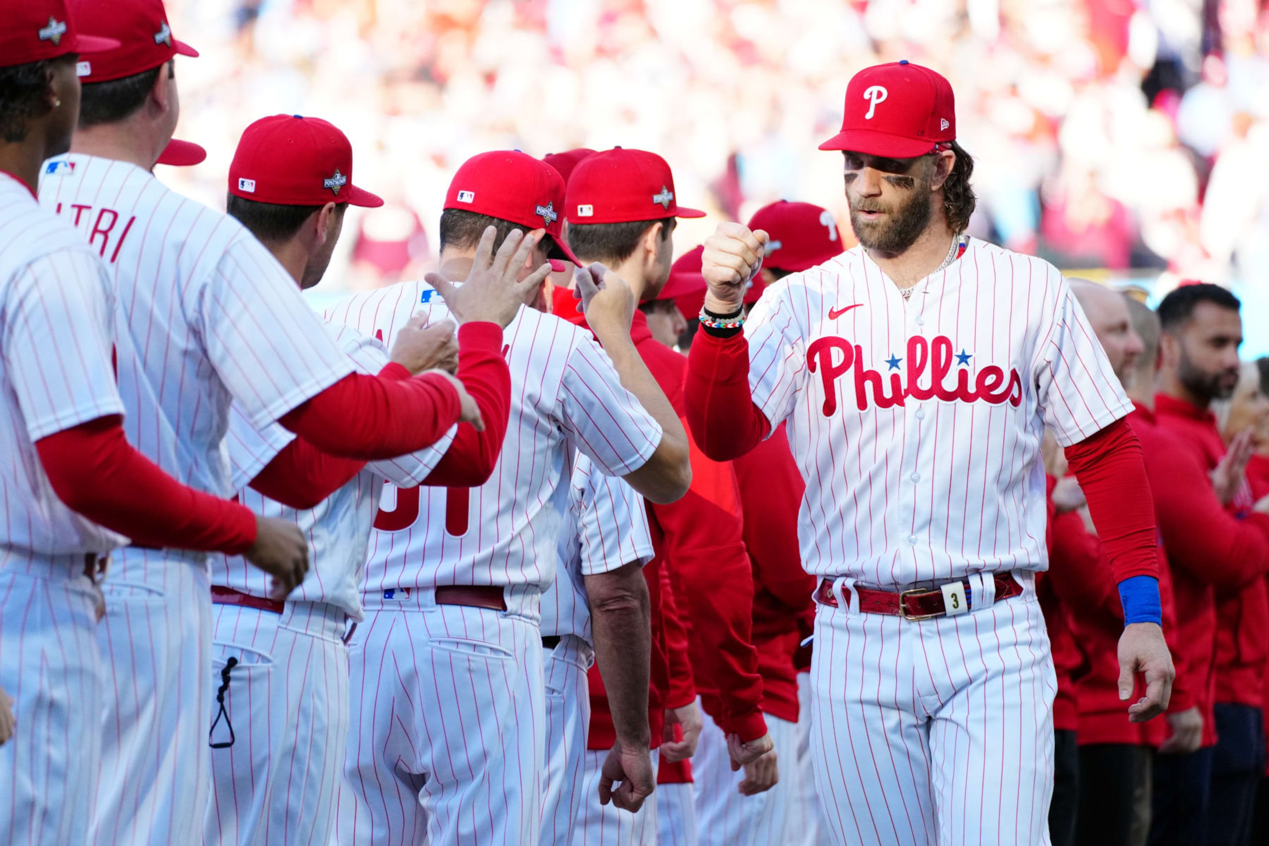 PHILADELPHIA, PA - OCTOBER 11:  Bryce Harper #3 of the Philadelphia Phillies is greeted by teammates during player introductions prior to Game 3 of the Division Series between the Atlanta Braves and the Philadelphia Phillies at Citizens Bank Park on Wednesday, October 11, 2023 in Philadelphia, Pennsylvania. (Photo by Mary DeCicco/MLB Photos via Getty Images)