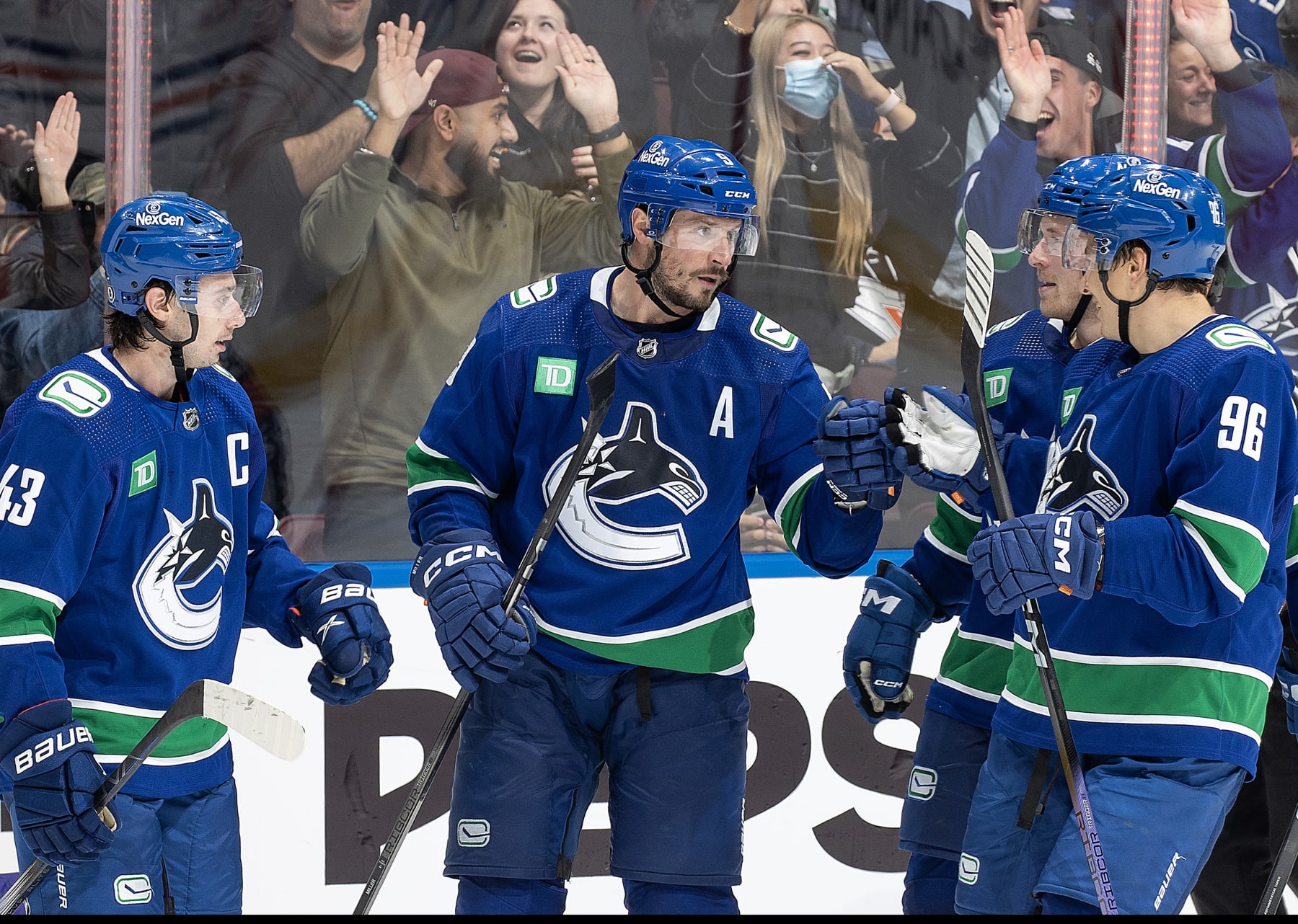 VANCOUVER, CANADA - OCTOBER 11: J.T. Miller #9 of the Vancouver Canucks celebrates his goal with teammates during the third period of their NHL game at Rogers Arena October 11, 2023 in Vancouver, British Columbia, Canada.  (Photo by Jeff Vinnick/NHLI via Getty Images)