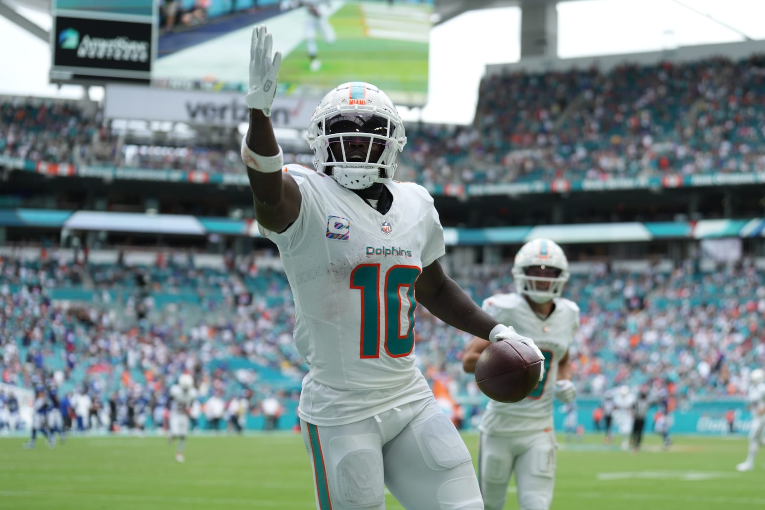 MIAMI GARDENS, FL - OCTOBER 08: Miami Dolphins wide receiver Tyreek Hill (10) looks for someone specific to give the touchdown ball to following his long touchdown catch and run in the second half during the game between the New York Giants and the Miami Dolphins on Sunday, October 8, 2023 at Hard Rock Stadium, Miami Gardens, Fla. (Photo by Peter Joneleit/Icon Sportswire via Getty Images)
