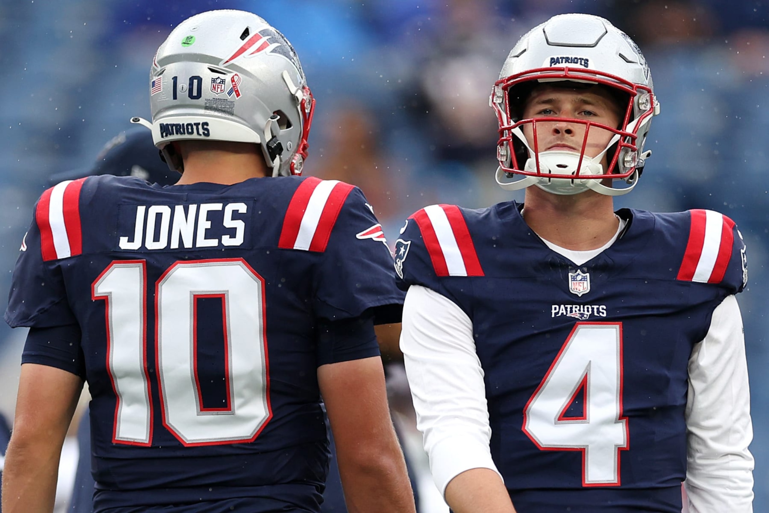 FOXBOROUGH, MASSACHUSETTS - SEPTEMBER 10: Bailey Zappe #4 of the New England Patriots looks on next to Mac Jones #10 before the game against the Philadelphia Eagles at Gillette Stadium on September 10, 2023 in Foxborough, Massachusetts. (Photo by Maddie Meyer/Getty Images) FOXBOROUGH, MASSACHUSETTS - SEPTEMBER 10: Bailey Zappe #4 of the New England Patriots looks on next to Mac Jones #10 before the game against the Philadelphia Eagles at Gillette Stadium on September 10, 2023 in Foxborough, Massachusetts. (Photo by Maddie Meyer/Getty Images)