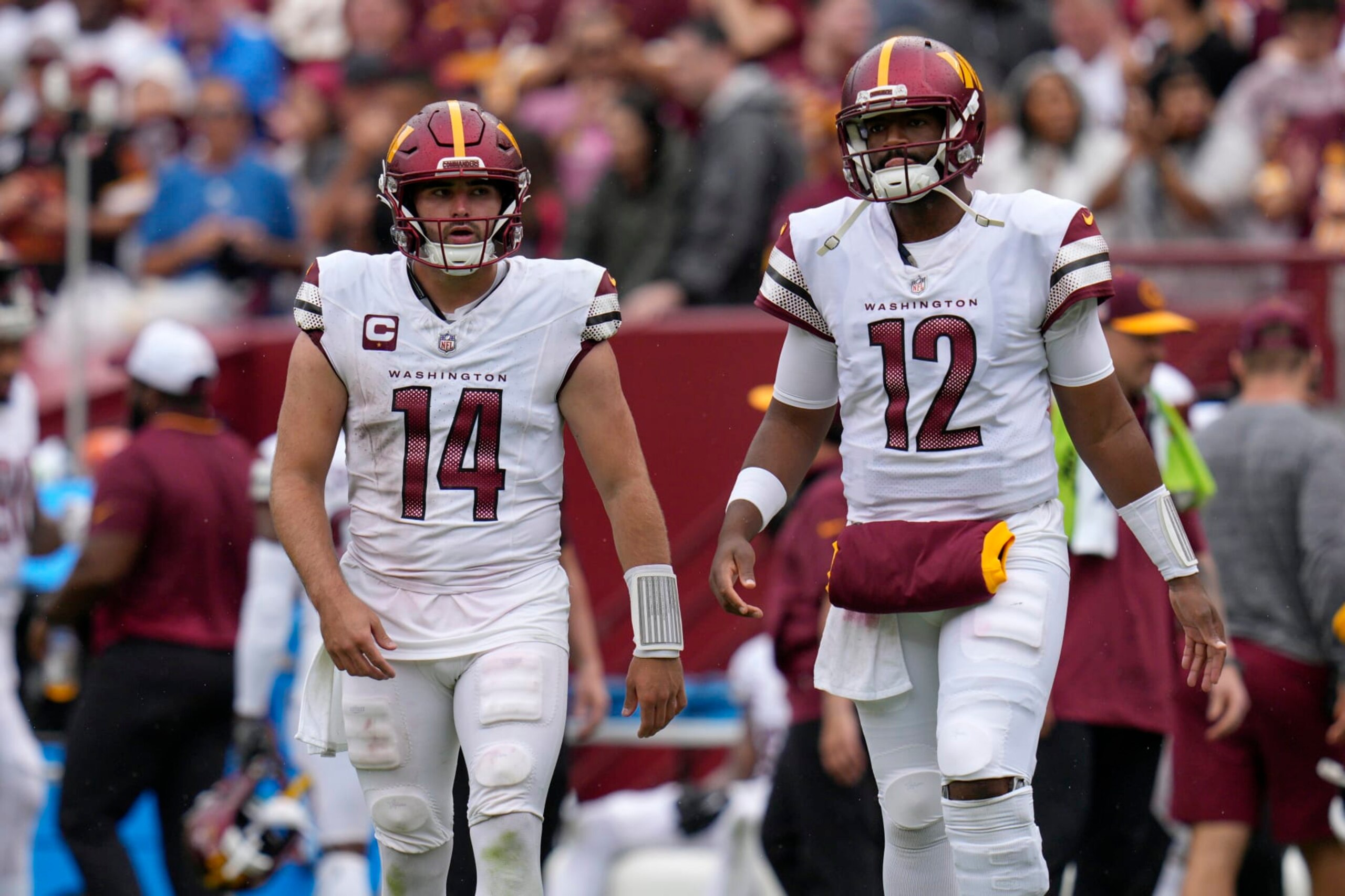 LANDOVER, MARYLAND - SEPTEMBER 10: Sam Howell #14 of the Washington Commanders and Jacoby Brissett #12 walk on the field tocelebrate with teammates after a successful extra point kick during the fourth quarter against the Arizona Cardinals at FedExField on September 10, 2023 in Landover, Maryland. (Photo by Jess Rapfogel/Getty Images) LANDOVER, MARYLAND - SEPTEMBER 10: Sam Howell #14 of the Washington Commanders and Jacoby Brissett #12 walk on the field tocelebrate with teammates after a successful extra point kick during the fourth quarter against the Arizona Cardinals at FedExField on September 10, 2023 in Landover, Maryland. (Photo by Jess Rapfogel/Getty Images)