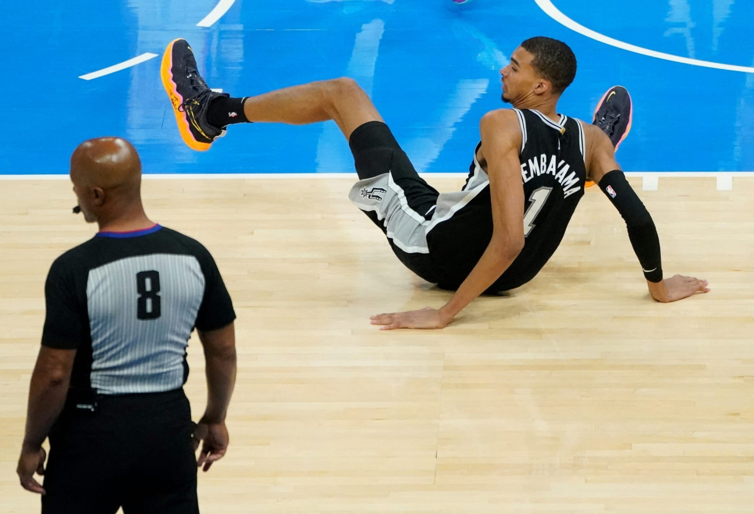 San Antonio Spurs French center #01 Victor Wembanyama falls on the court during the NBA pre-season basketball game between San Antonio Spurs and Oklahoma City Thunder at Paycom Center arena in Oklahoma City, Oklahoma, on October 9, 2023. (Photo by TIMOTHY A. CLARY / AFP) (Photo by TIMOTHY A. CLARY/AFP via Getty Images)