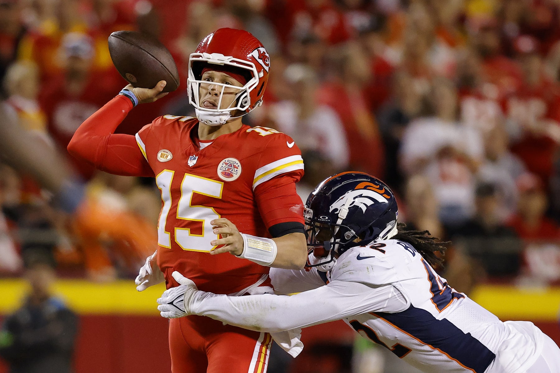 KANSAS CITY, MISSOURI - OCTOBER 12: Nik Bonitto #42 of the Denver Broncos pressures Patrick Mahomes #15 of the Kansas City Chiefs during the second quarter at GEHA Field at Arrowhead Stadium on October 12, 2023 in Kansas City, Missouri. (Photo by David Eulitt/Getty Images)