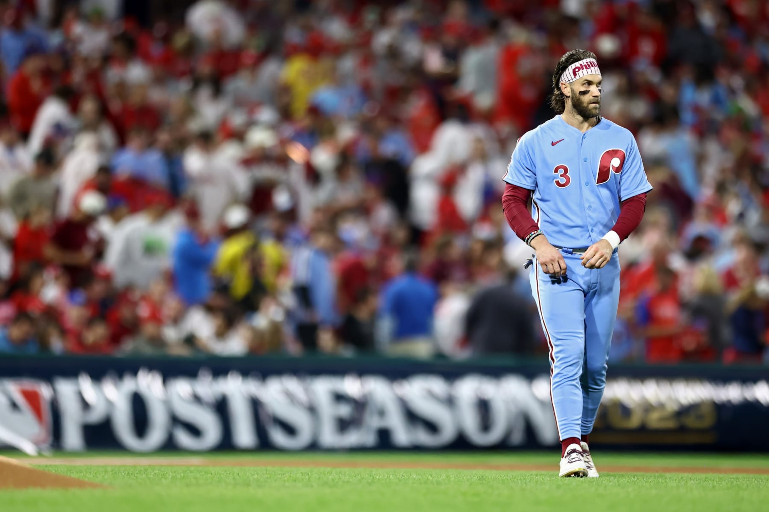 PHILADELPHIA, PENNSYLVANIA - OCTOBER 12: Bryce Harper #3 of the Philadelphia Phillies walks across the field after the first inning against the Atlanta Braves during Game Four of the Division Series at Citizens Bank Park on October 12, 2023 in Philadelphia, Pennsylvania. (Photo by Tim Nwachukwu/Getty Images)