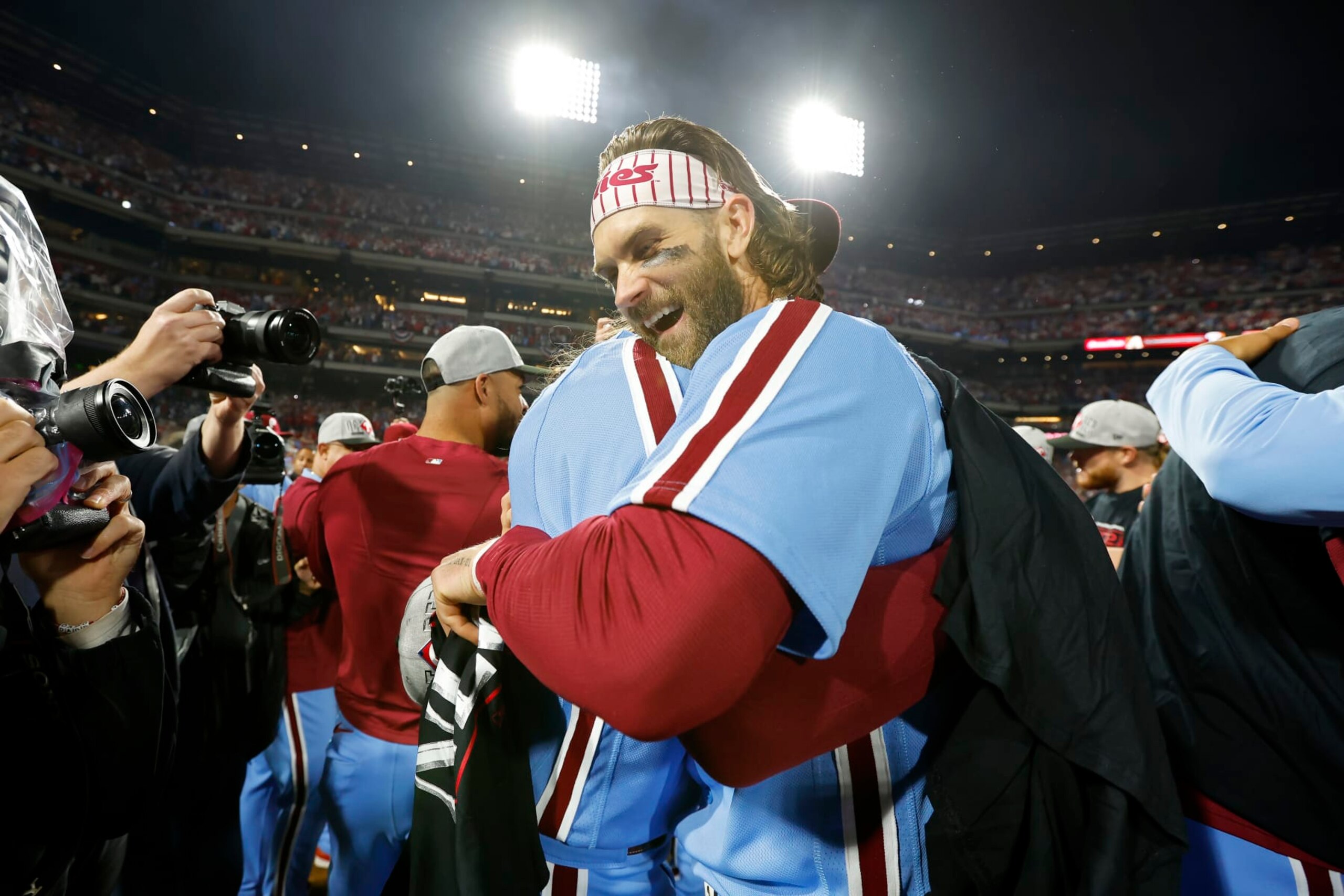 PHILADELPHIA, PENNSYLVANIA - OCTOBER 12: Brandon Marsh #16 and Bryce Harper #3 of the Philadelphia Phillies celebrate after beating the Atlanta Braves 3-1 in Game Four of the Division Series at Citizens Bank Park on October 12, 2023 in Philadelphia, Pennsylvania. (Photo by Rich Schultz/Getty Images)
